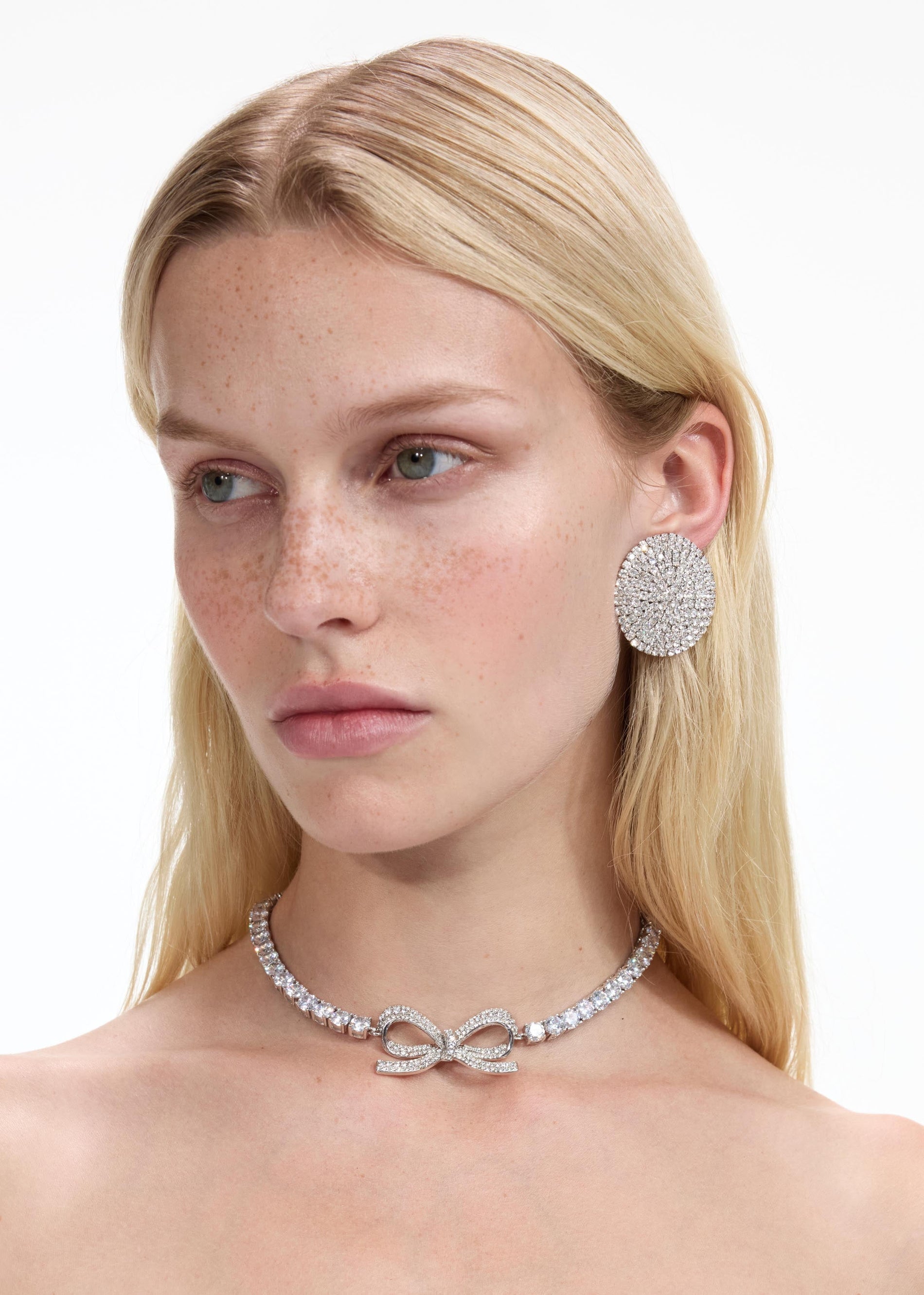 Back view of a woman wearing the Large Round Crystal Earrings