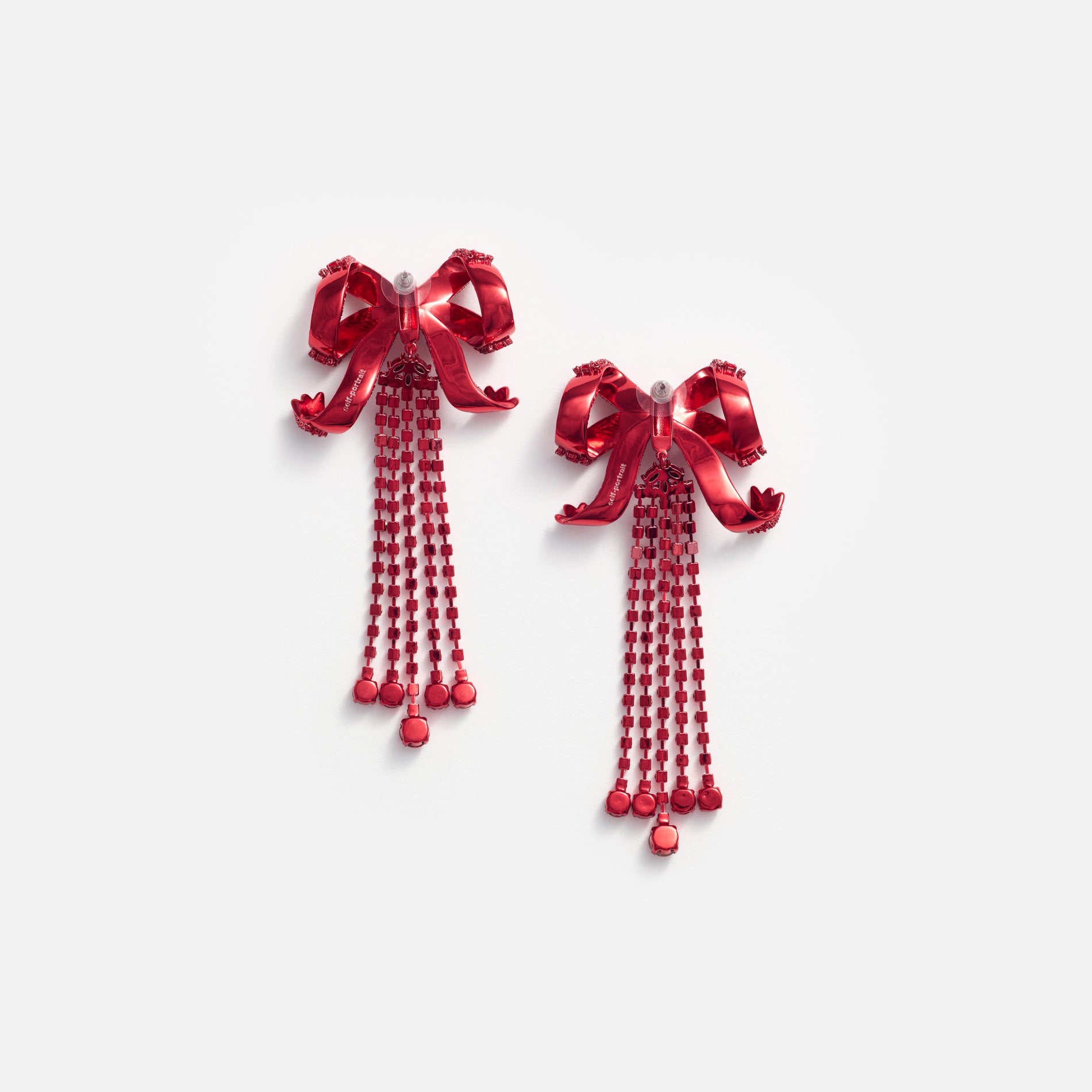 Side view of a woman wearing the Red Bow Diamante Earrings