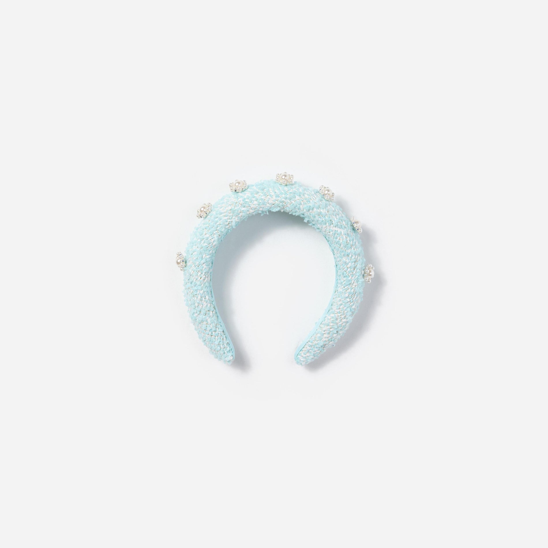 Front view of a woman wearing the Mint Boucle 3D Flower Headband