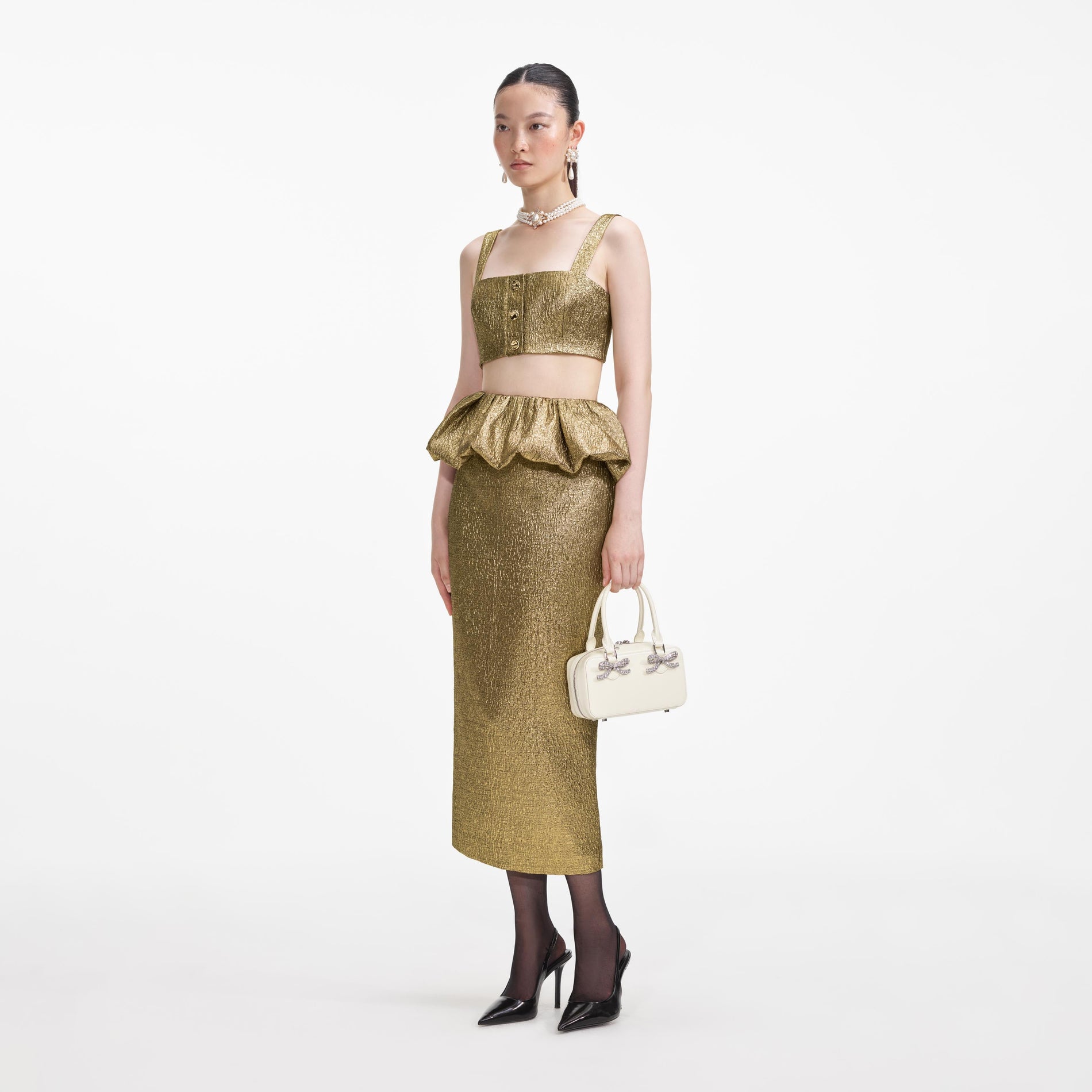 Side view of a woman wearing the Gold Metallic Jacquard Midi Skirt