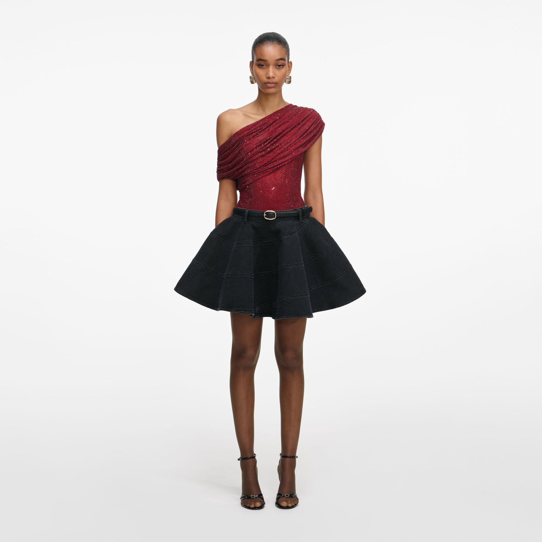 Front view of a woman wearing the Black Flared Denim Mini Skirt