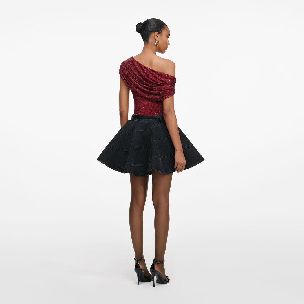 Back view of a woman wearing the Burgundy Rhinestone Drape Top