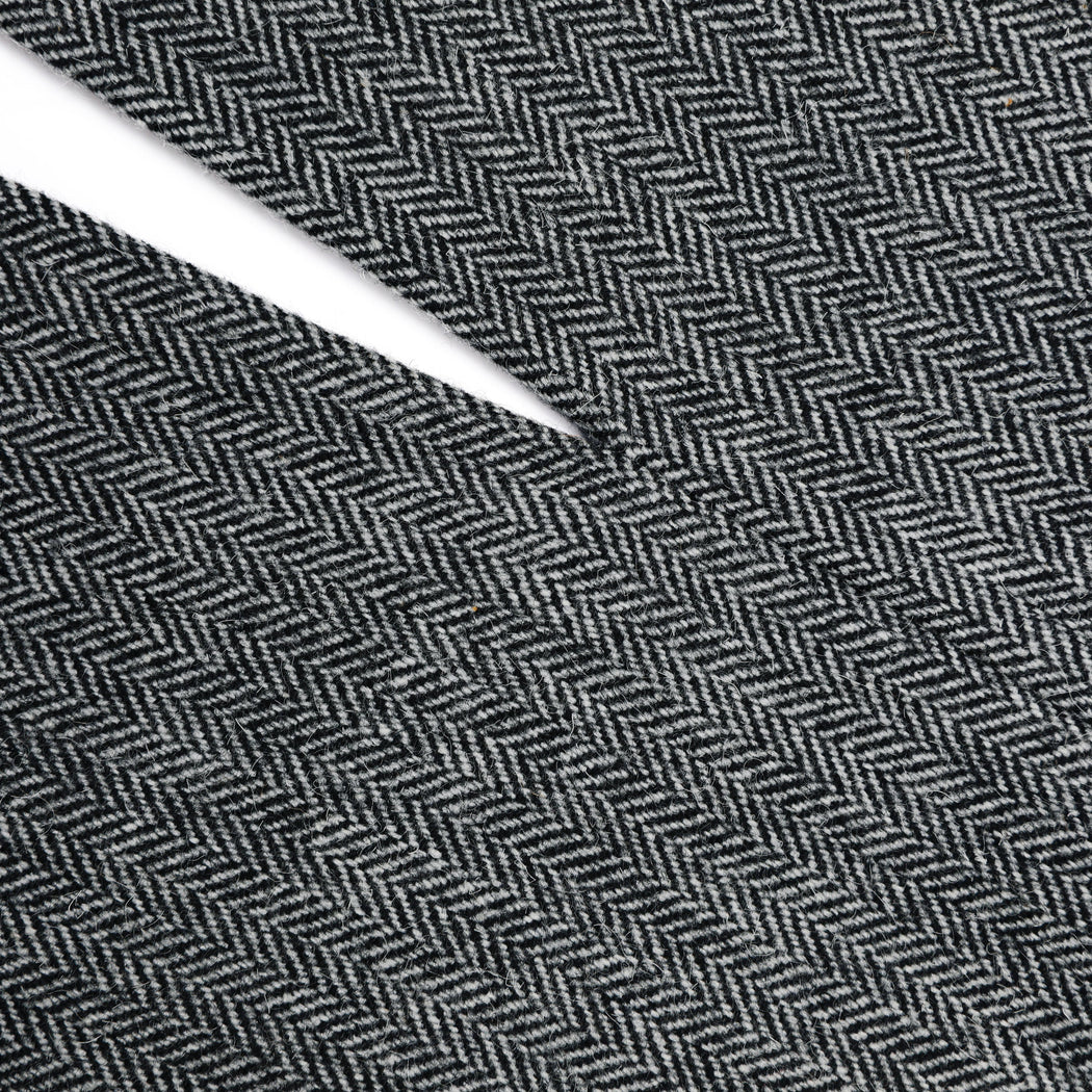 A close up of a woman wearing the Grey Herringbone Midi Skirt