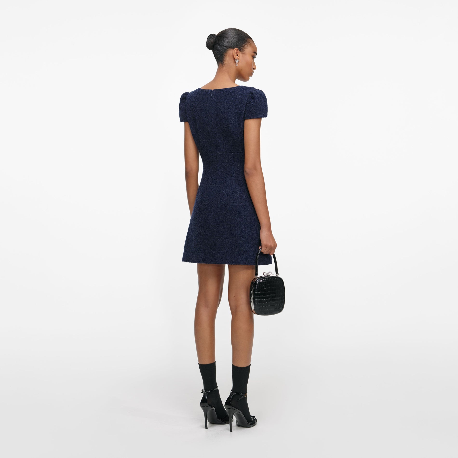 Back view of a woman wearing the Navy Textured Boucle Mini Dress