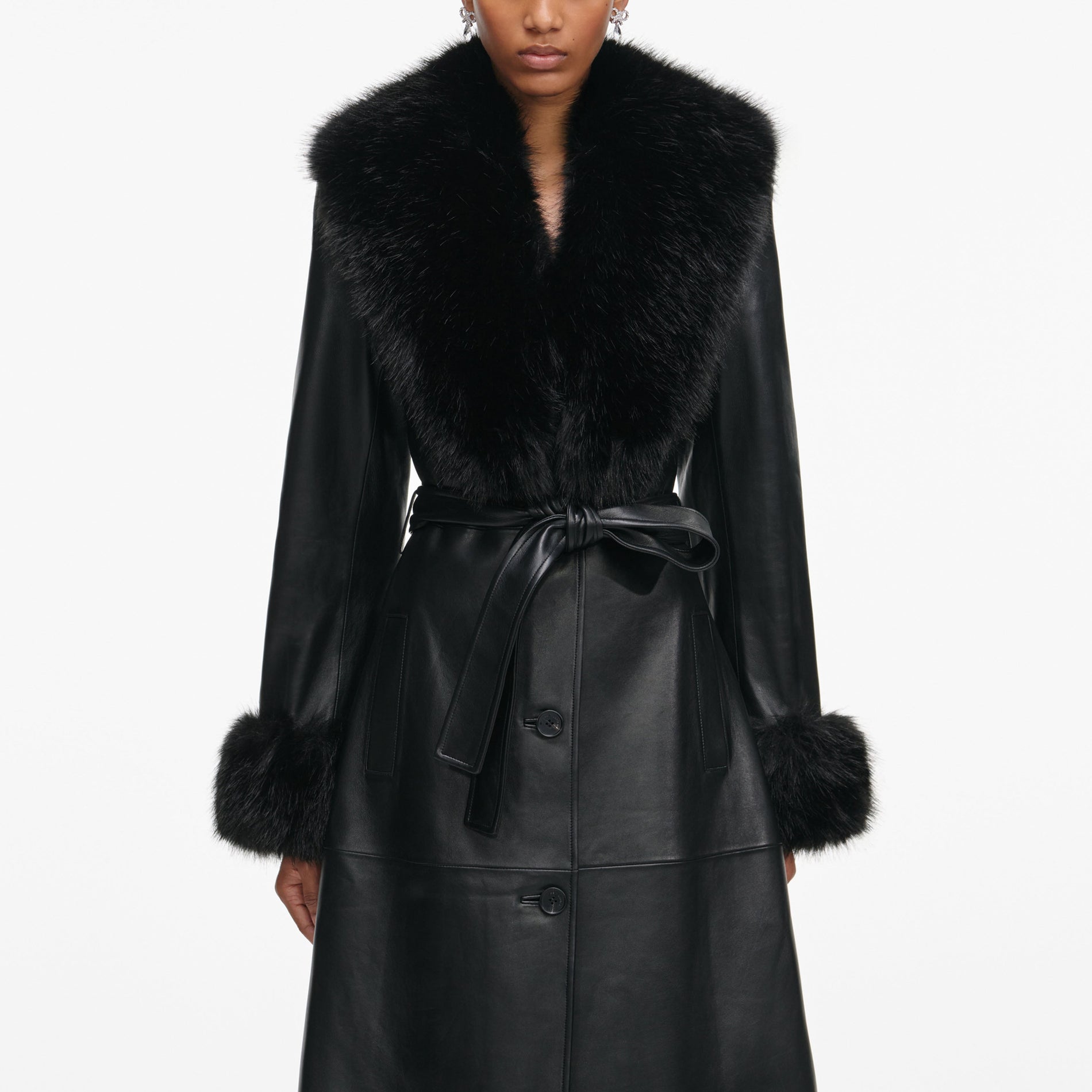 Side view of a woman wearing the Black Leather Faux Fur Collared Coat