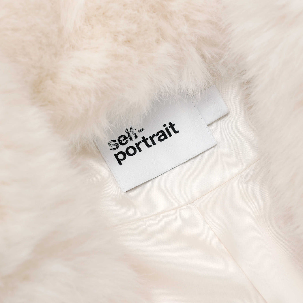 A close up of the fabric for the White Faux Fur Coat