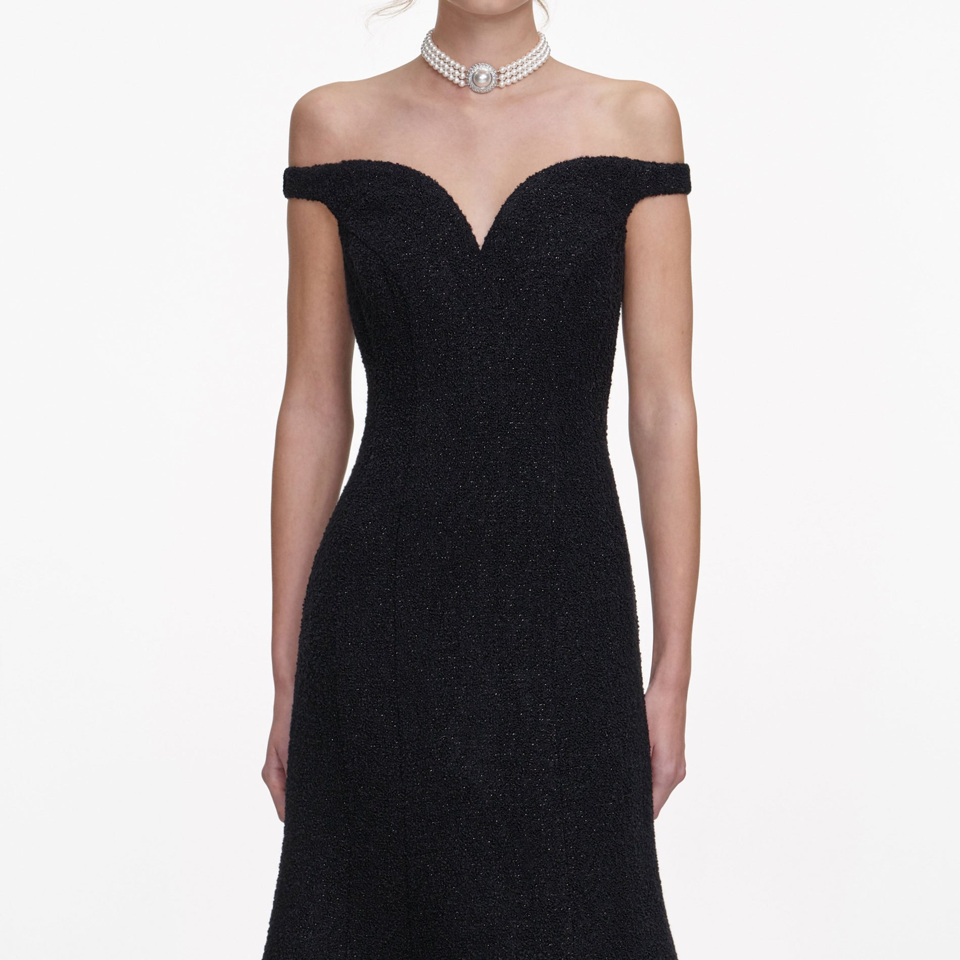 A close up of a woman wearing the Black Boucle Midi Dress