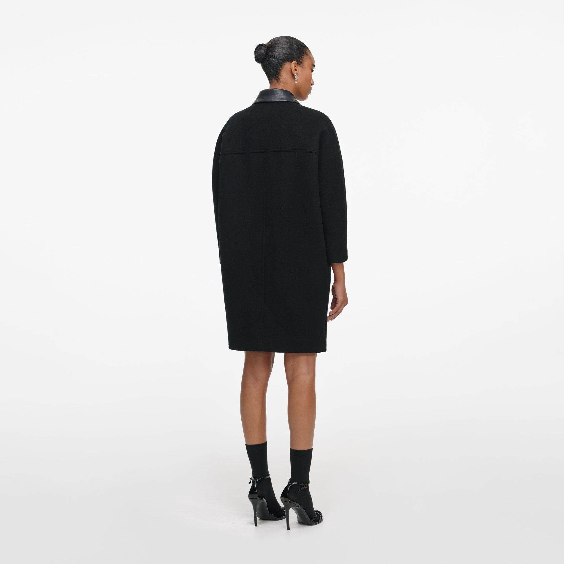 Back view of a woman wearing the Black Double Breasted Coat