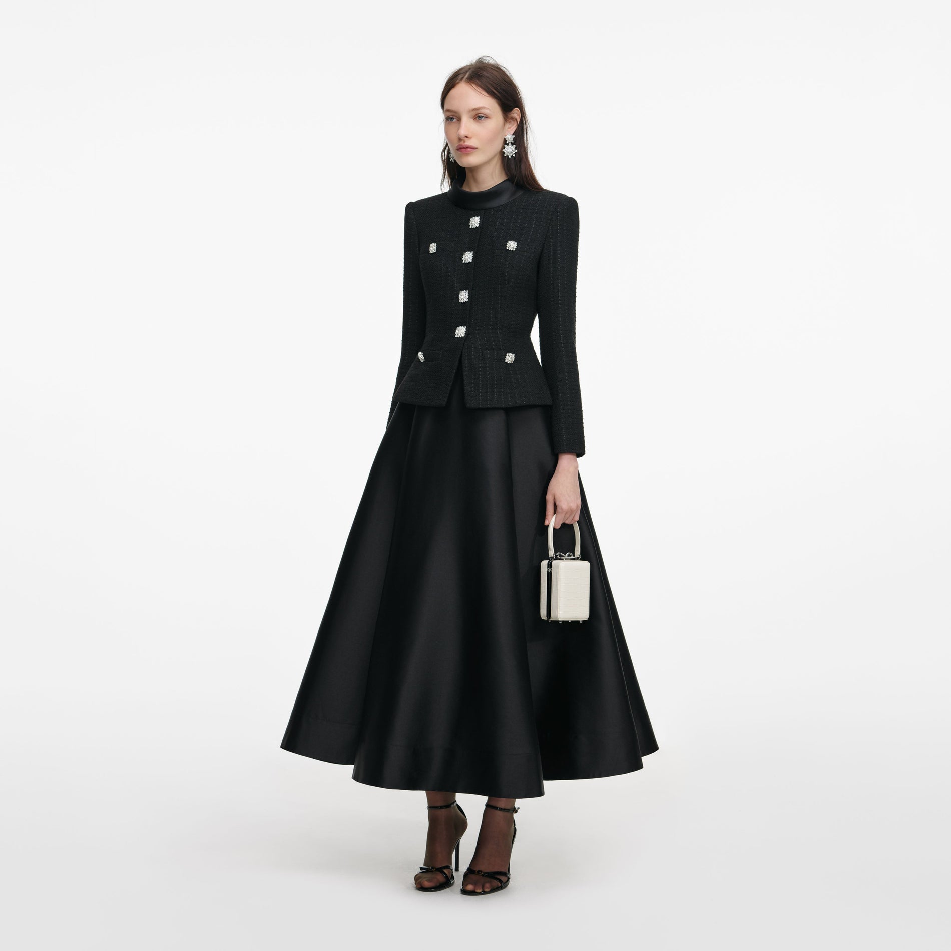 Side view of a woman wearing the Black Boucle Taffeta Midi Dress