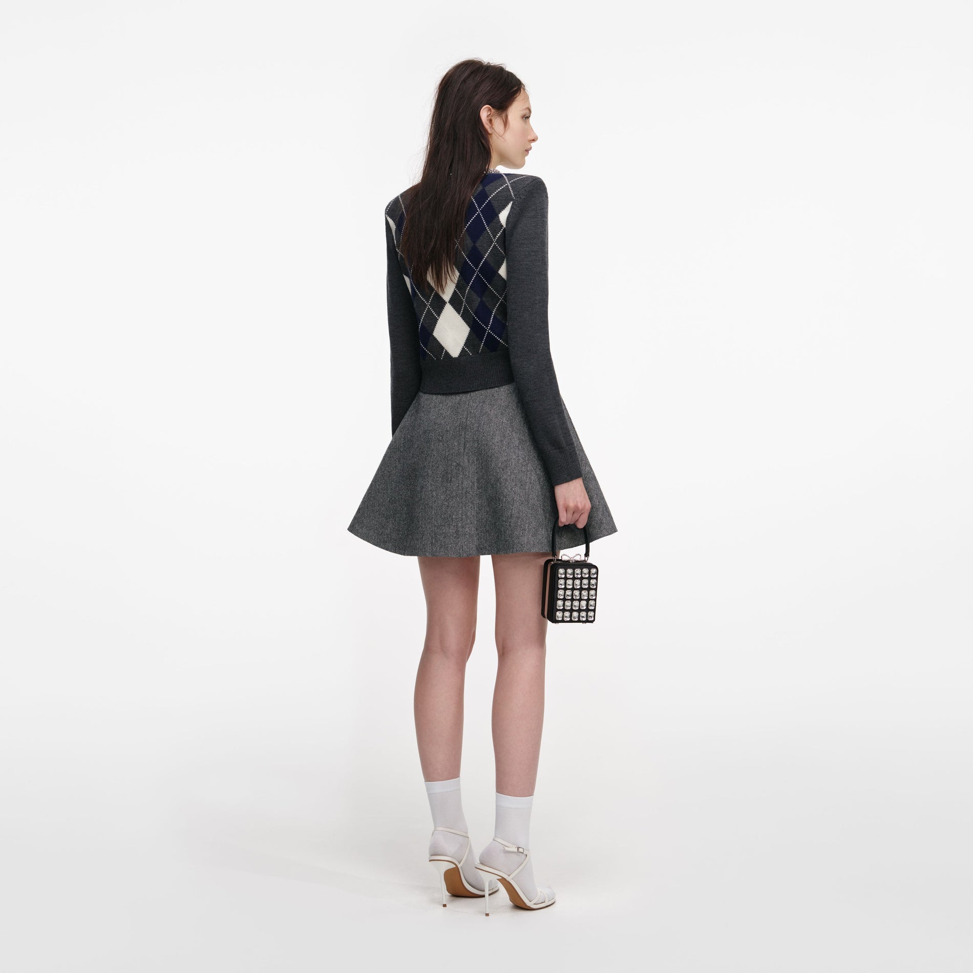 Back view of a woman wearing the Grey Herringbone Flared Mini Skirt