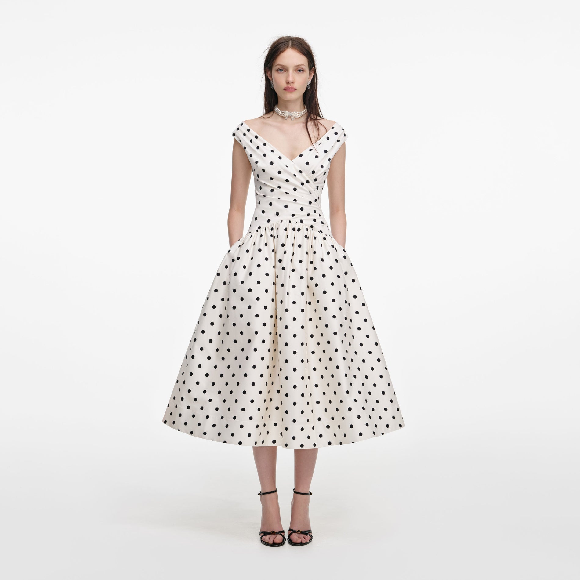 Front view of a woman wearing the Cream Polka Dot Cotton Midi Dress