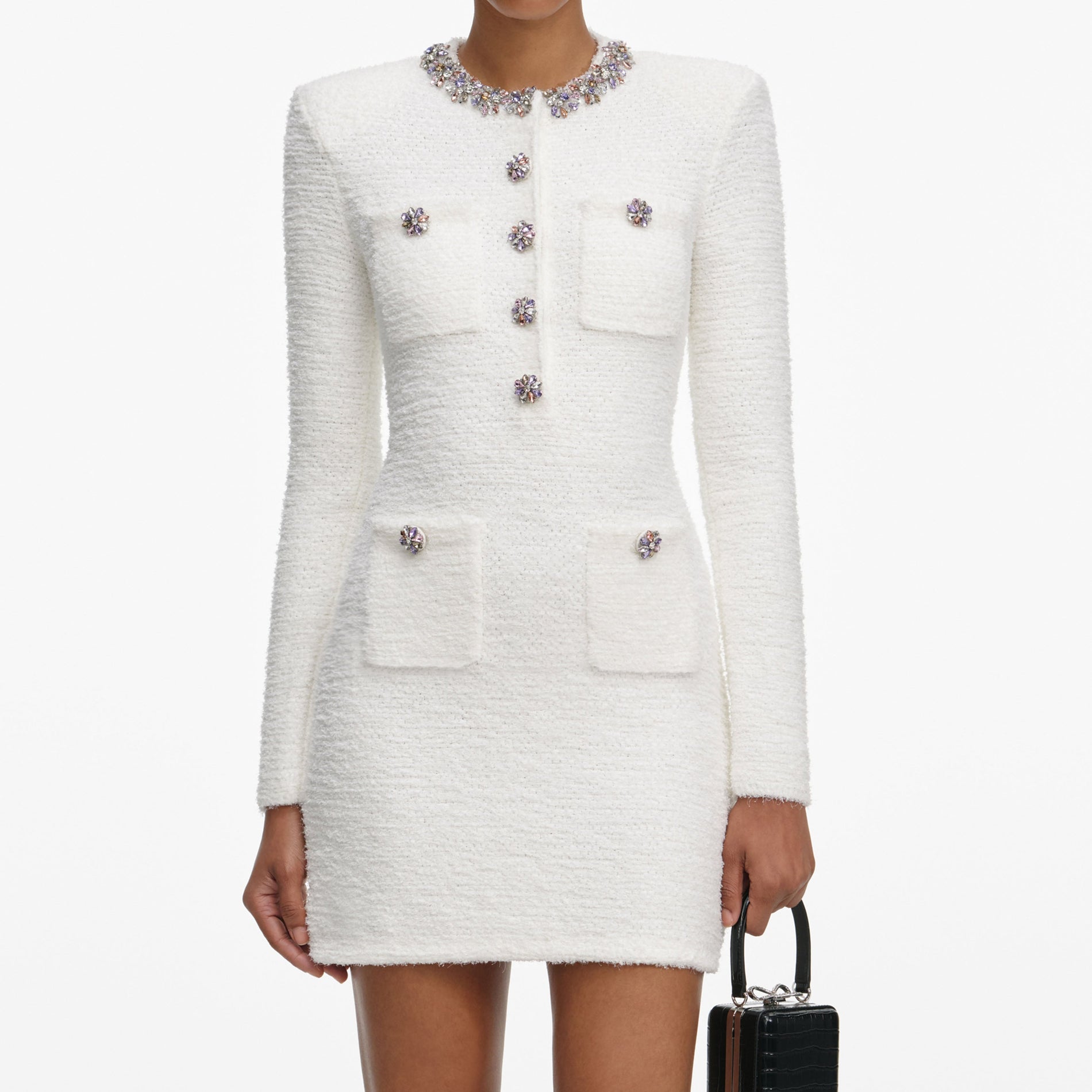 A close up of a woman wearing the Cream Crystal Trim Knit Mini Dress