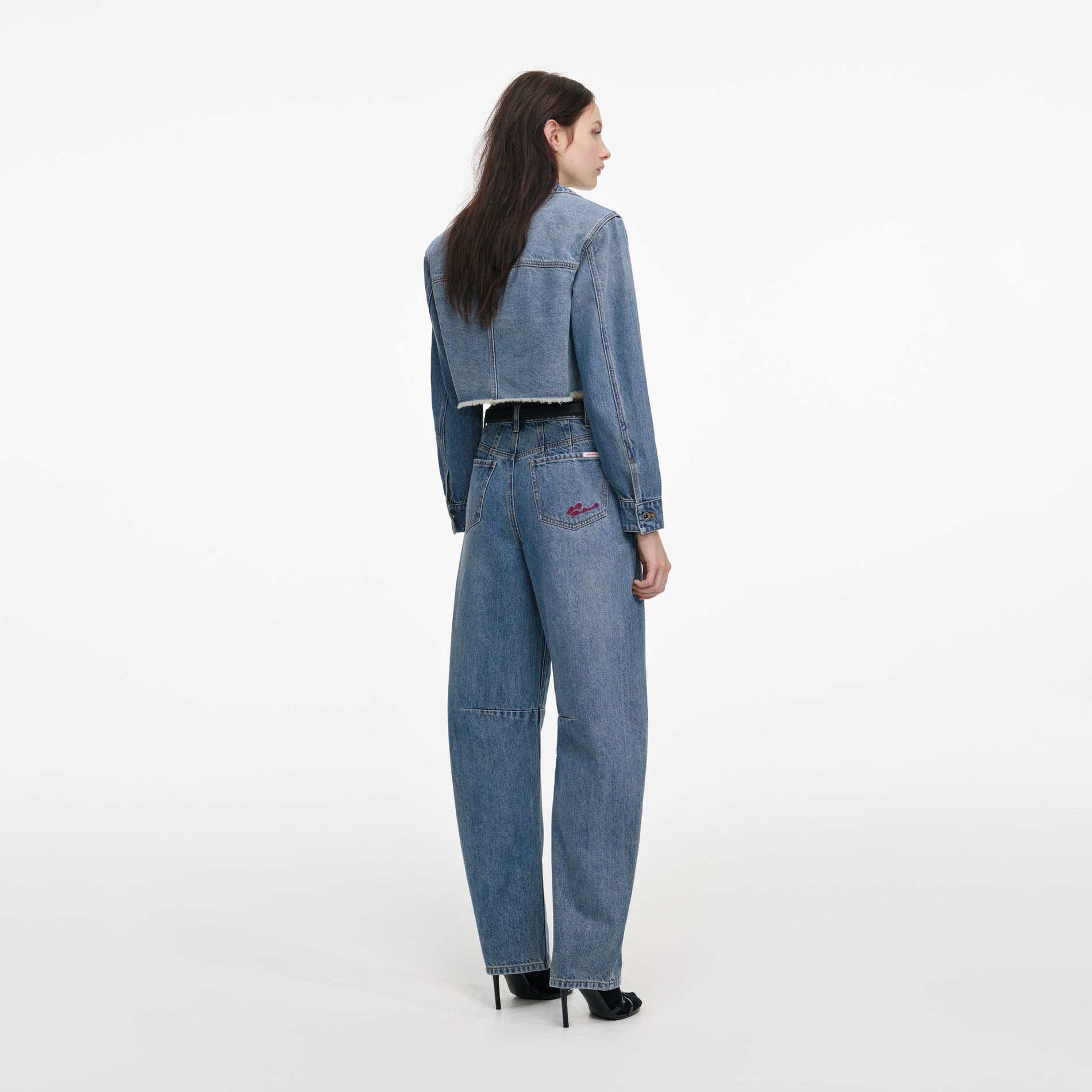Back view of a woman wearing the Cropped Denim Shirt