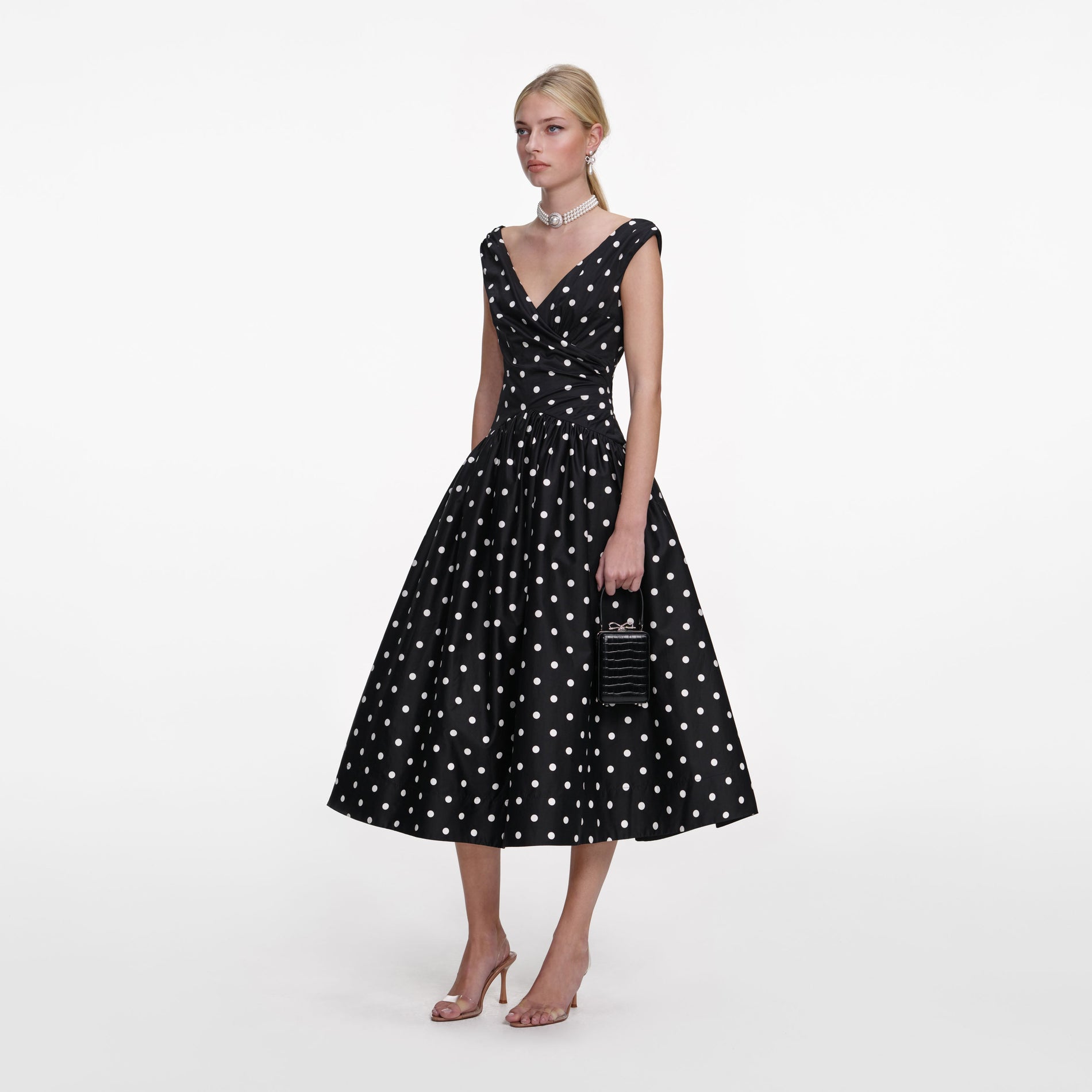Side view of a woman wearing the Black Cotton Midi Dress