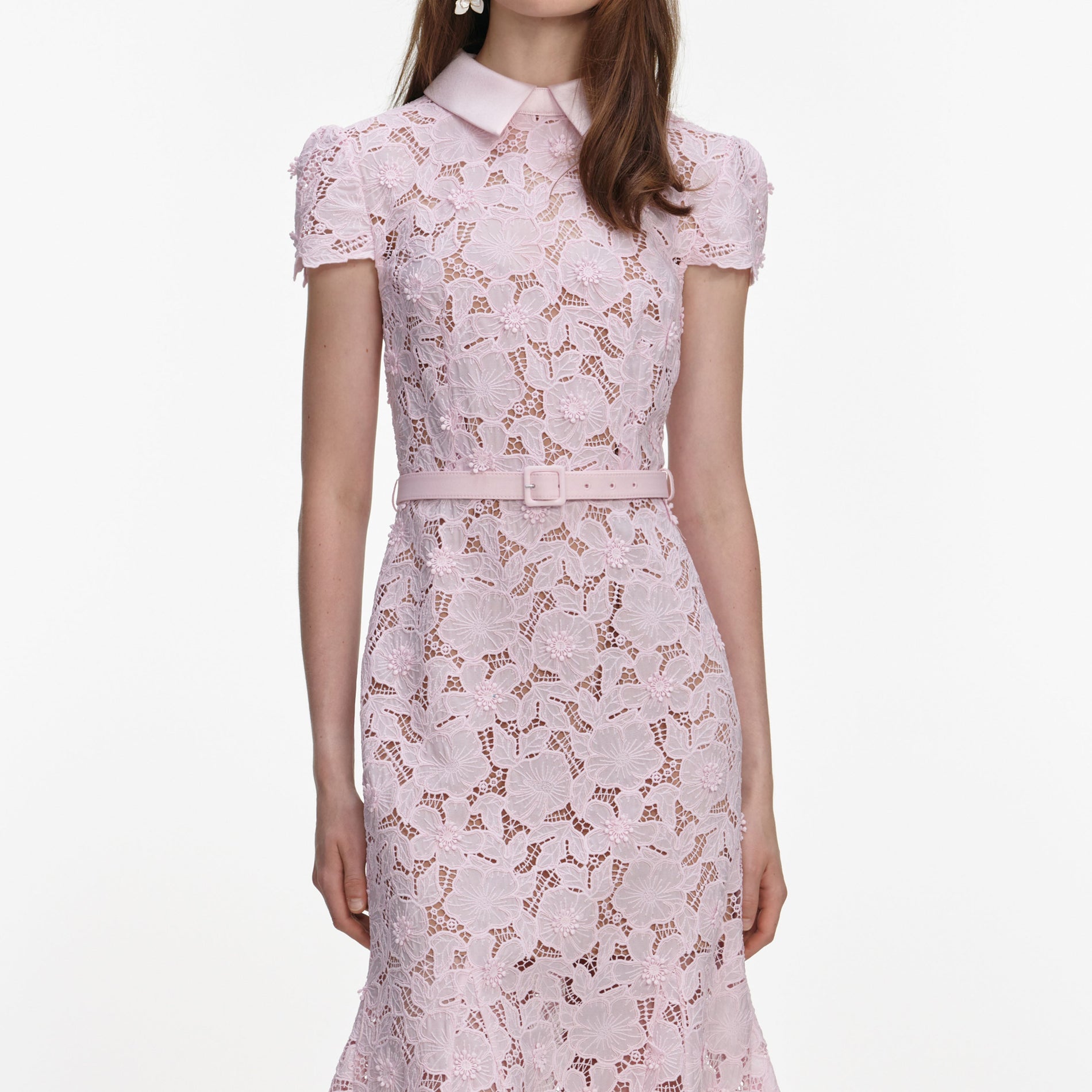 A close up of a woman wearing the Pink Guipure Lace Midi Dress