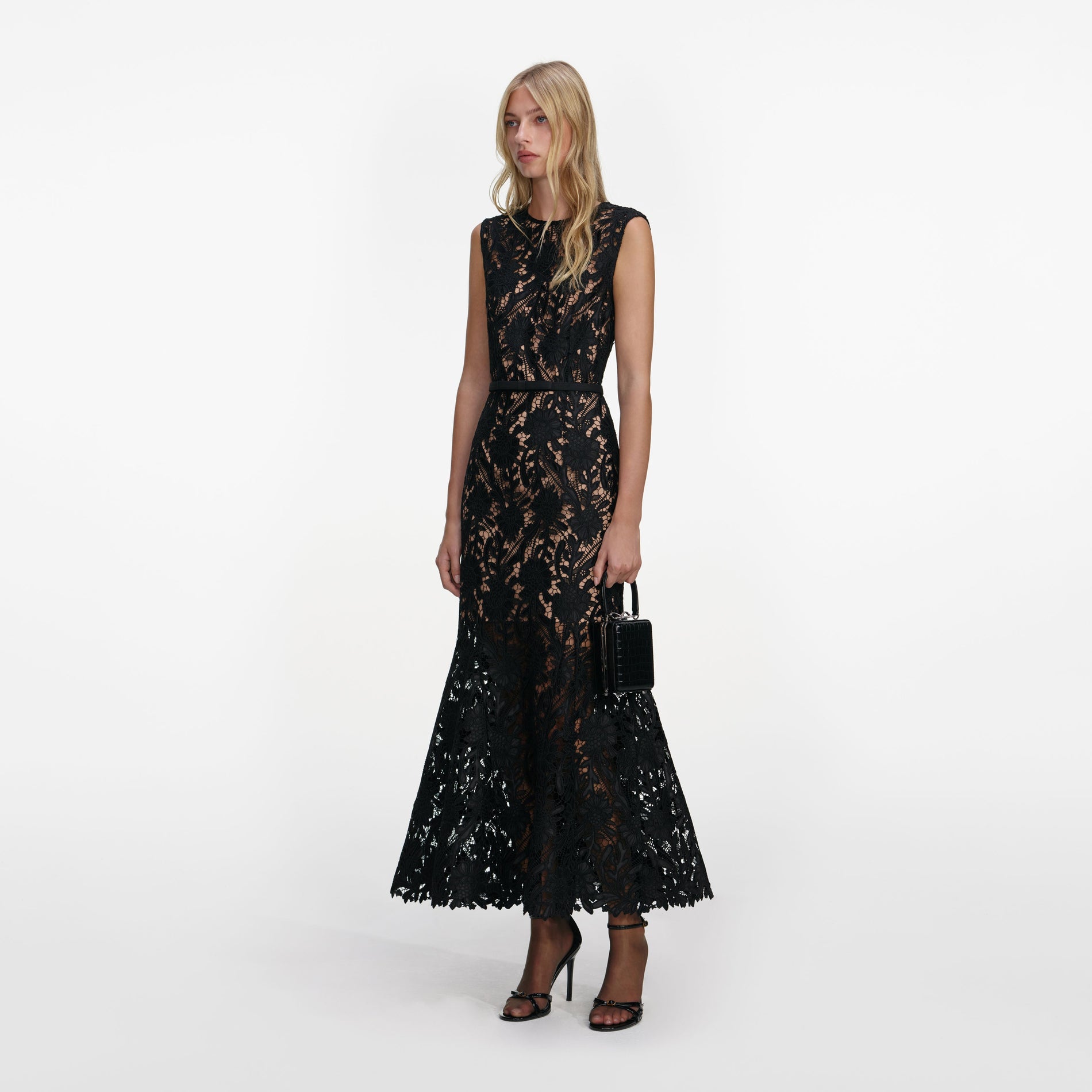 Side view of a woman wearing the Black Guipure Lace Midi Dress
