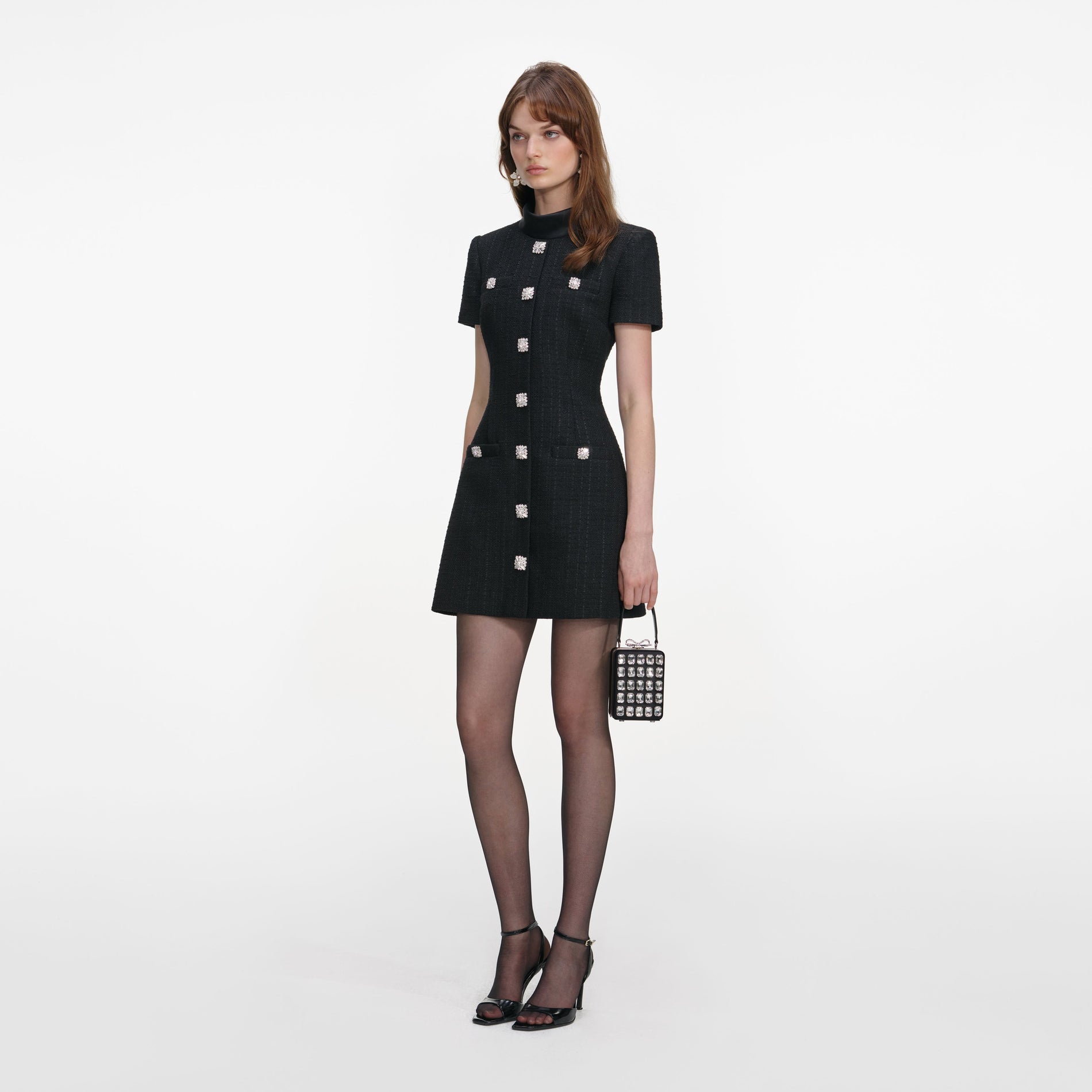 Side view of a woman wearing the Black Boucle Collared Mini Dress