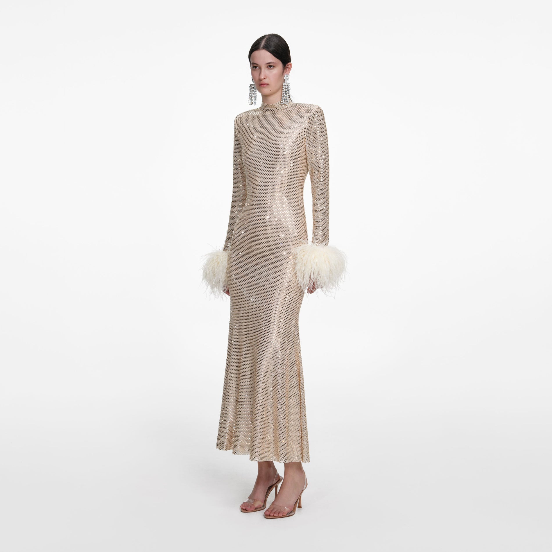 Side view of a woman wearing the Champagne Rhinestone Feather Midi Dress