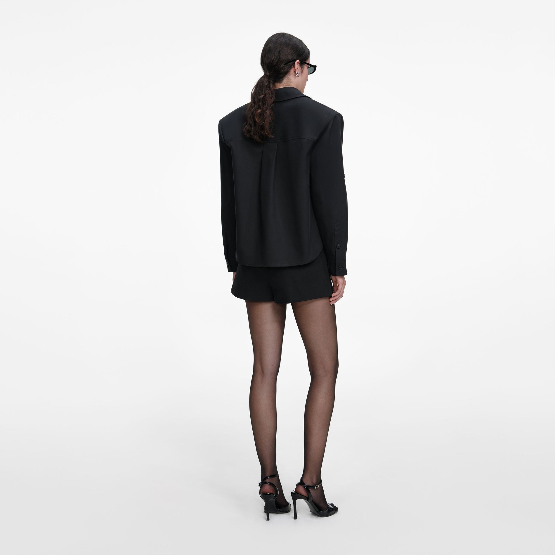Back view of a woman wearing the Black Cotton Shirt