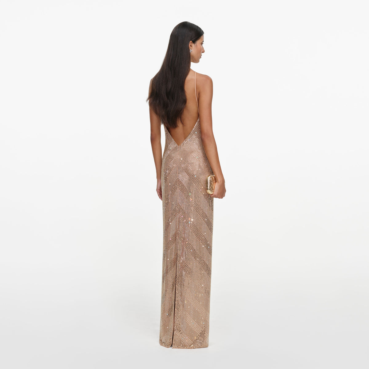Back view of a woman wearing the Champagne Chevron Rhinestone Halterneck Maxi Dress