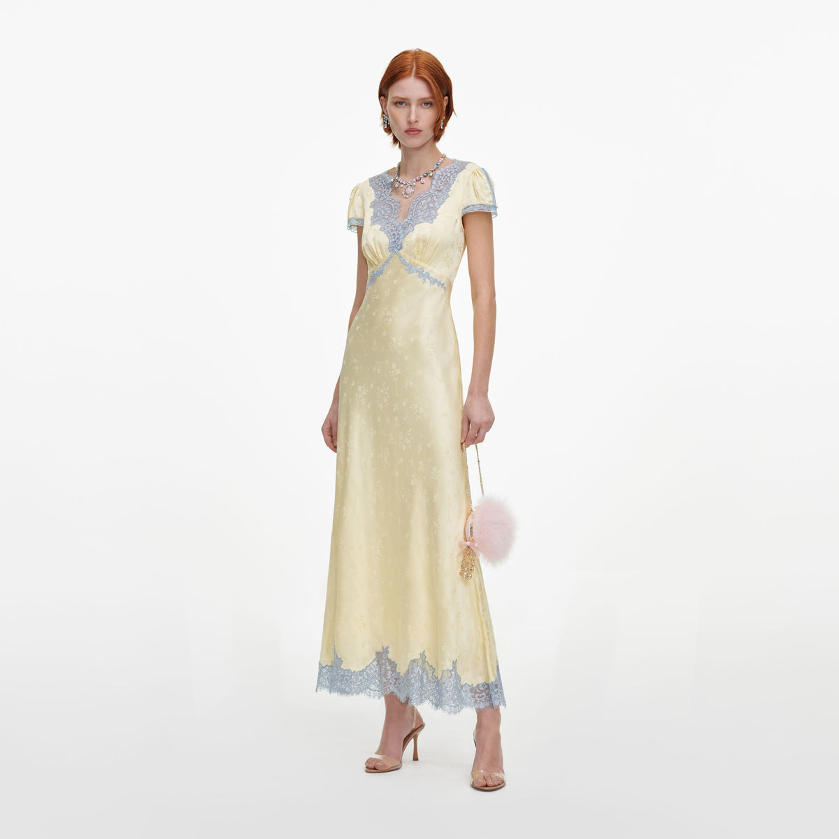 Side view of a woman wearing the Yellow Viscose Lace Midi Dress