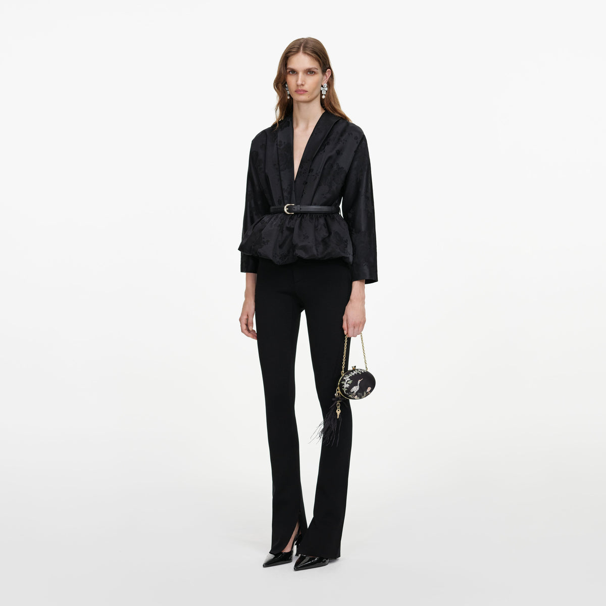 Side view of a woman wearing the Black Jacquard Peplum Top