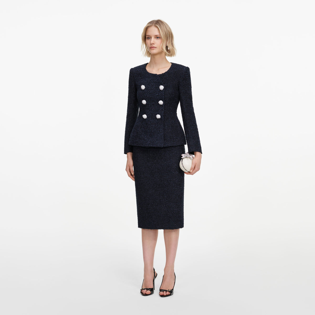 Side view of a woman wearing the Navy Boucle Midi Dress