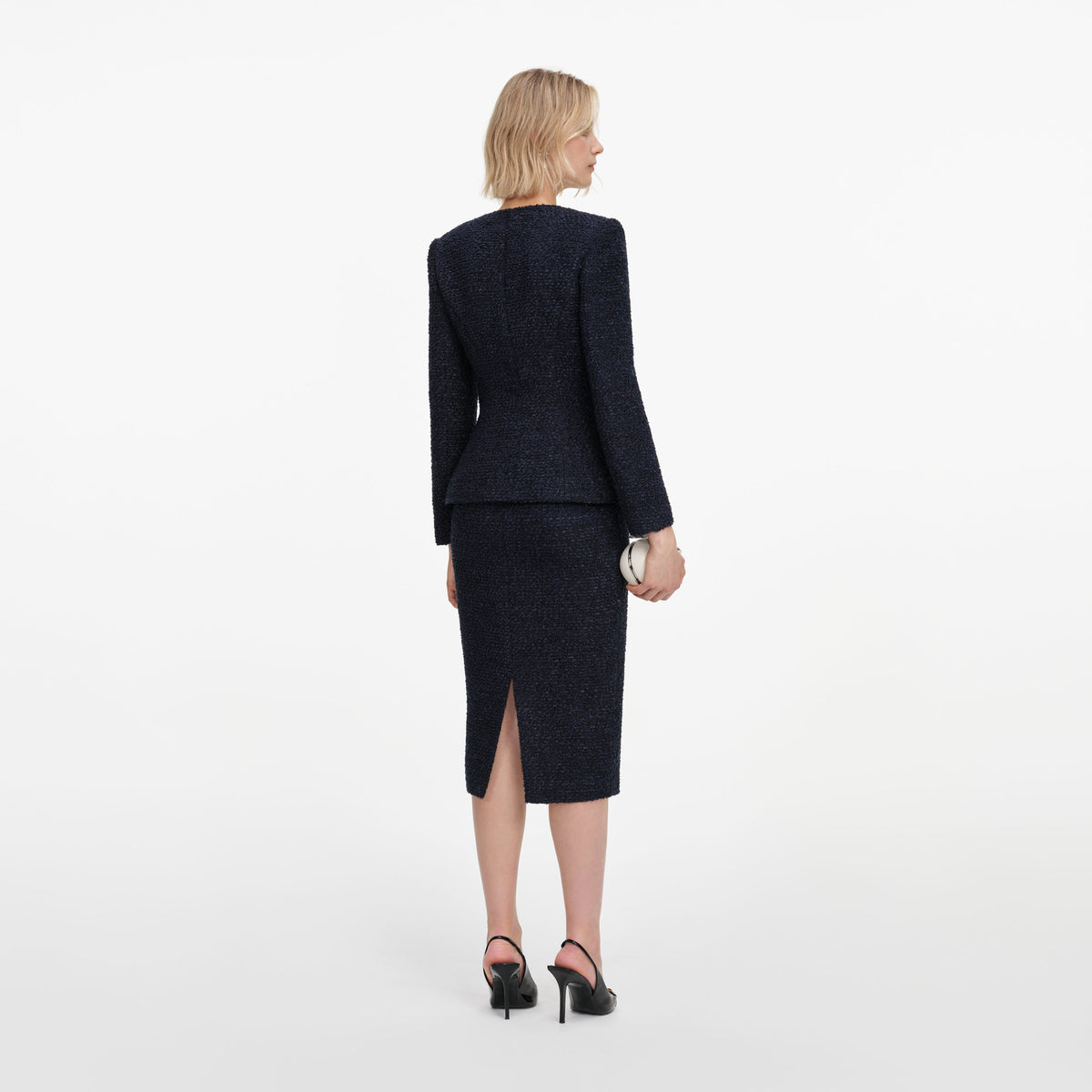 Back view of a woman wearing the Navy Boucle Midi Dress
