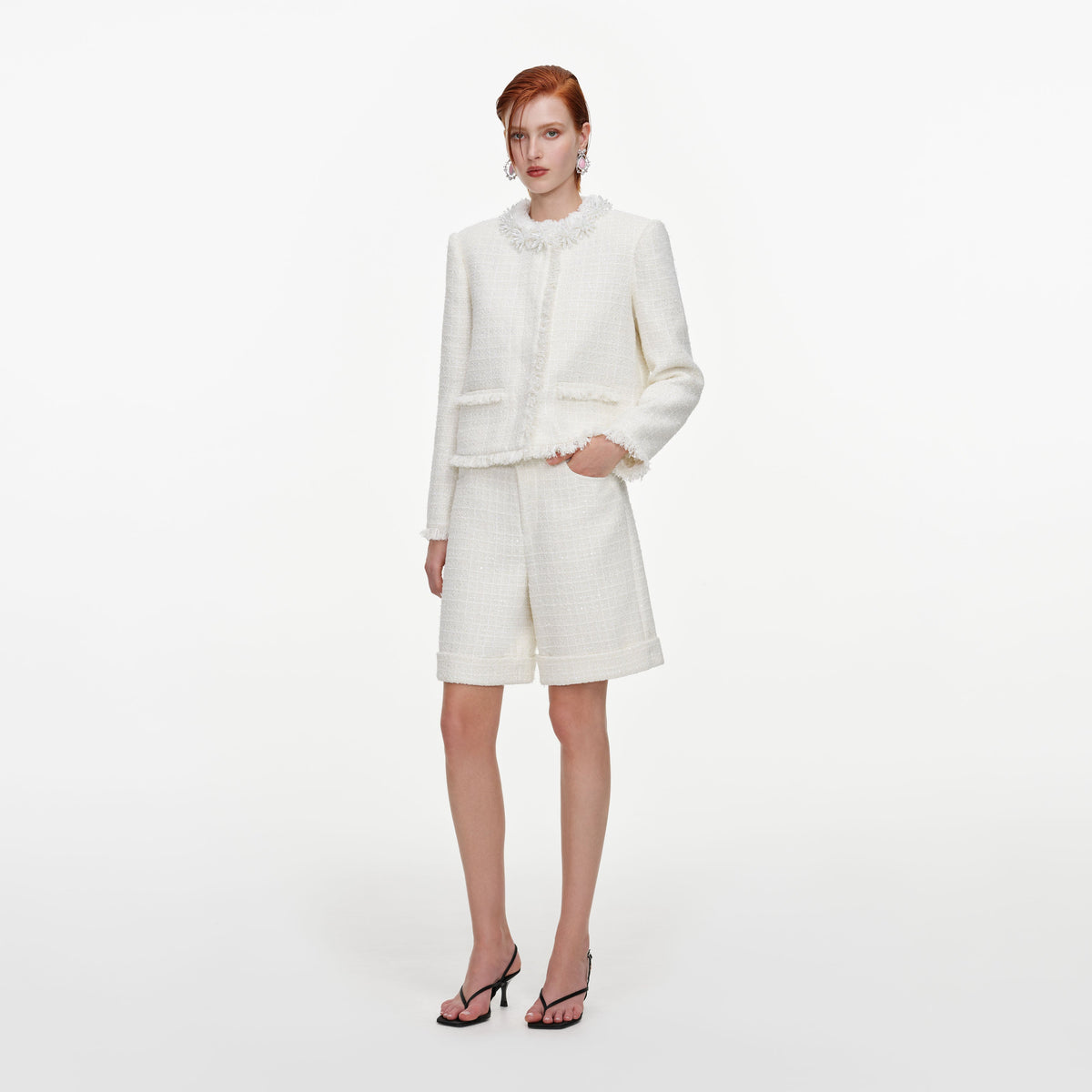 Side view of a woman wearing the Cream Sequin Boucle Pearl Trim Jacket