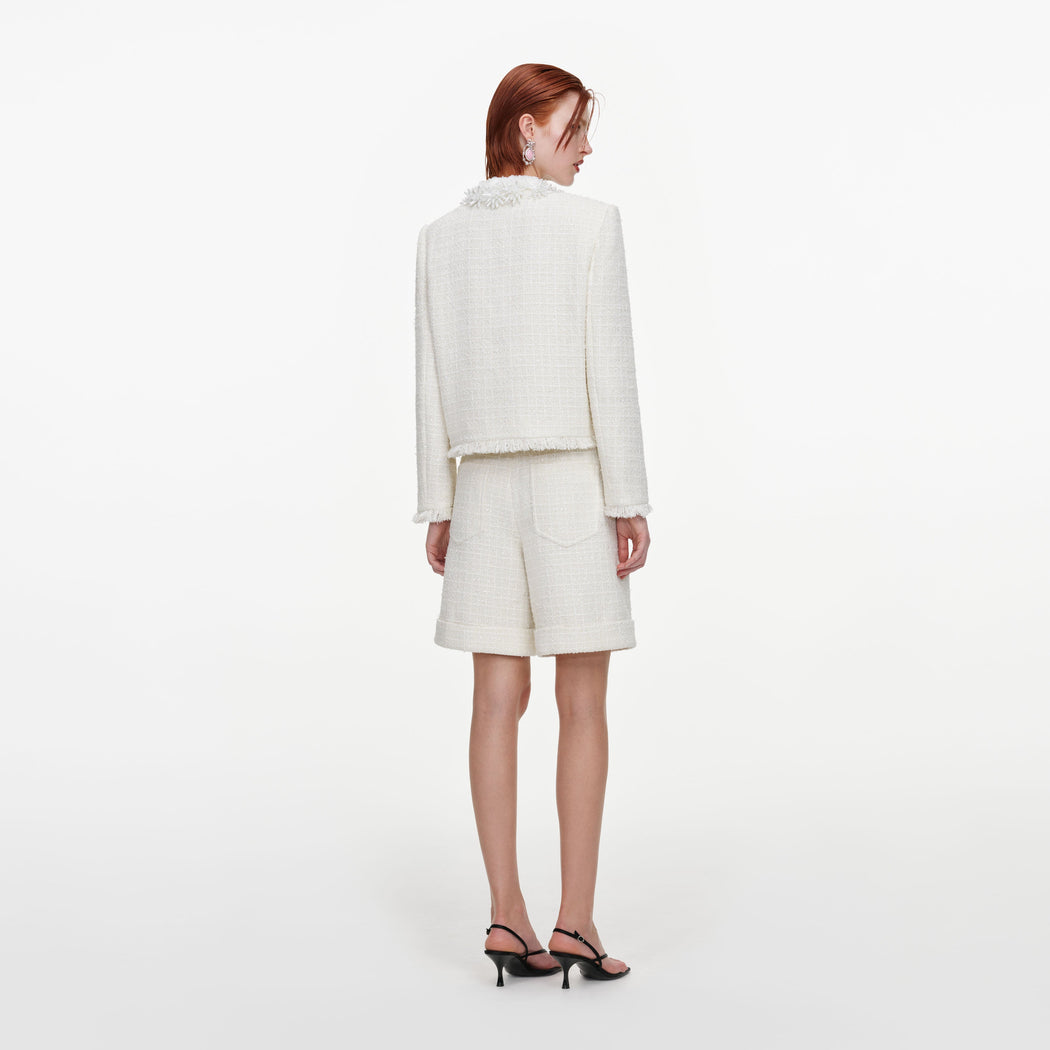Back view of a woman wearing the Cream Sequin Boucle Pearl Trim Jacket