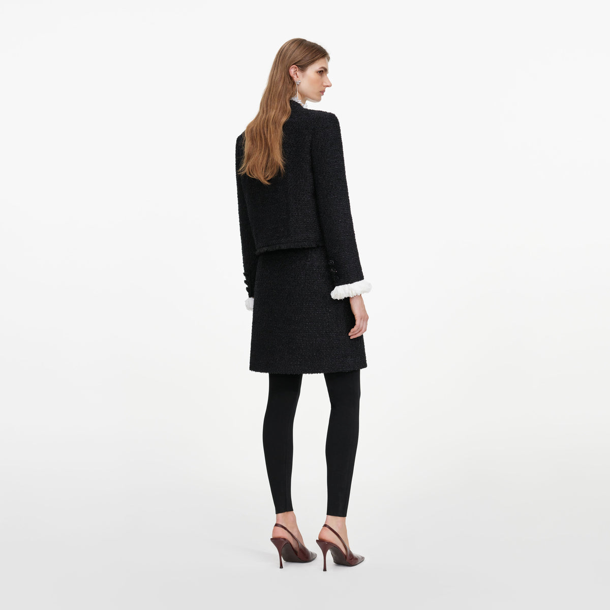 Back view of a woman wearing the Black Boucle Flower Jacket