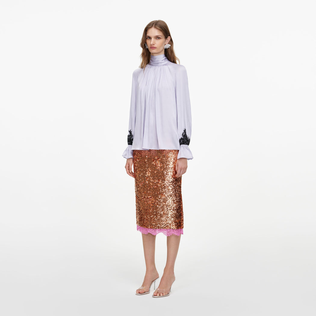Side view of a woman wearing the Lilac Viscose Contrast Lace Blouse