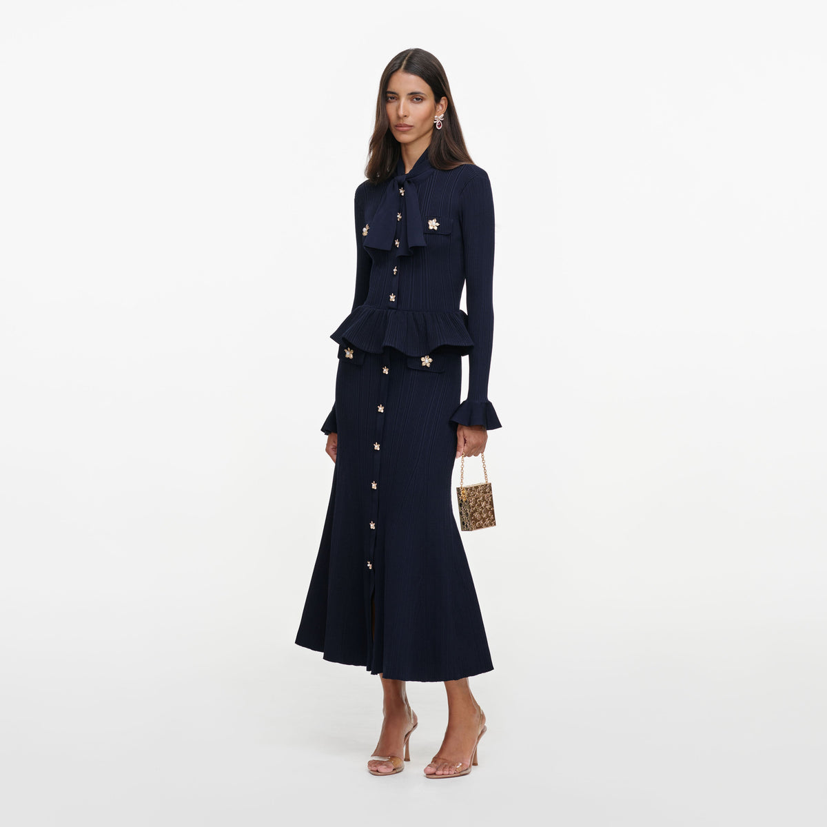 Side view of a woman wearing the Navy Peplum Knit Midi Dress
