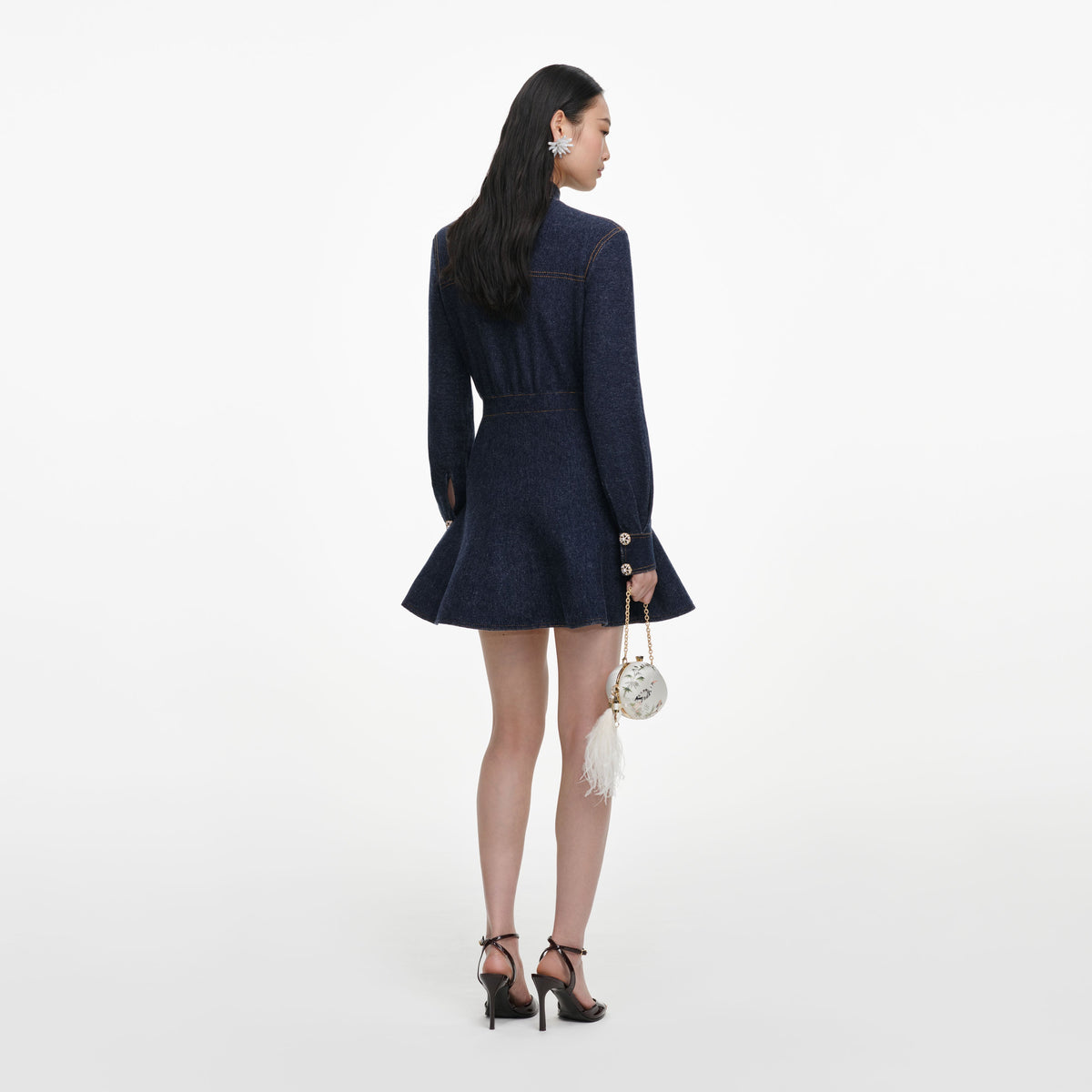 Back view of a woman wearing the Navy Textured Knit Mini Dress
