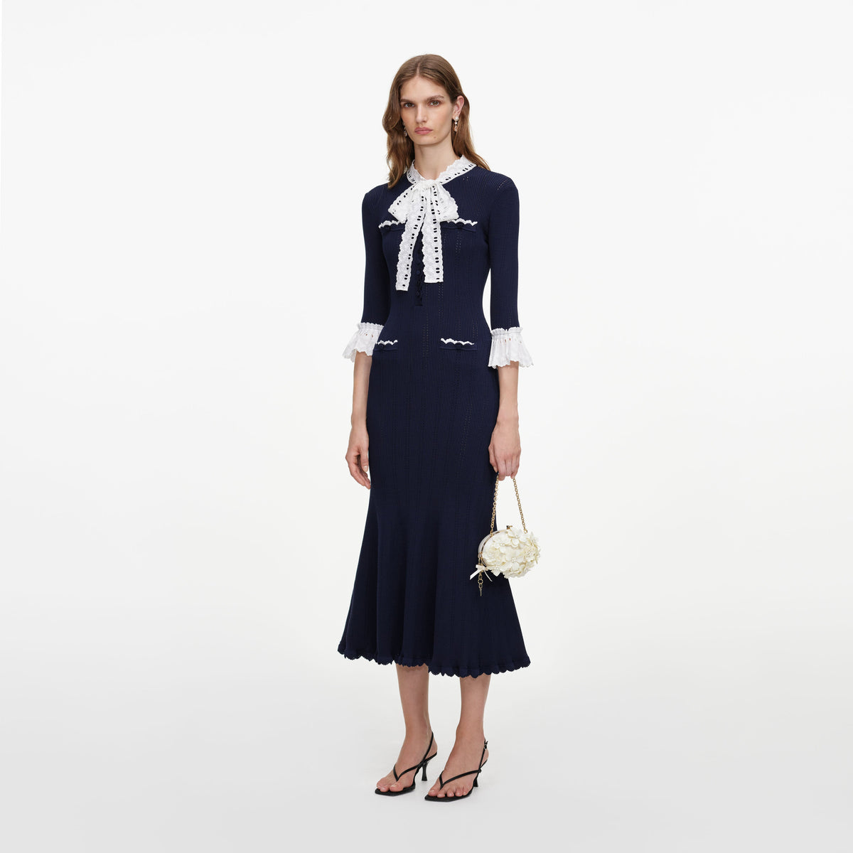 Side view of a woman wearing the Navy Pointelle Lace Knit Midi Dress