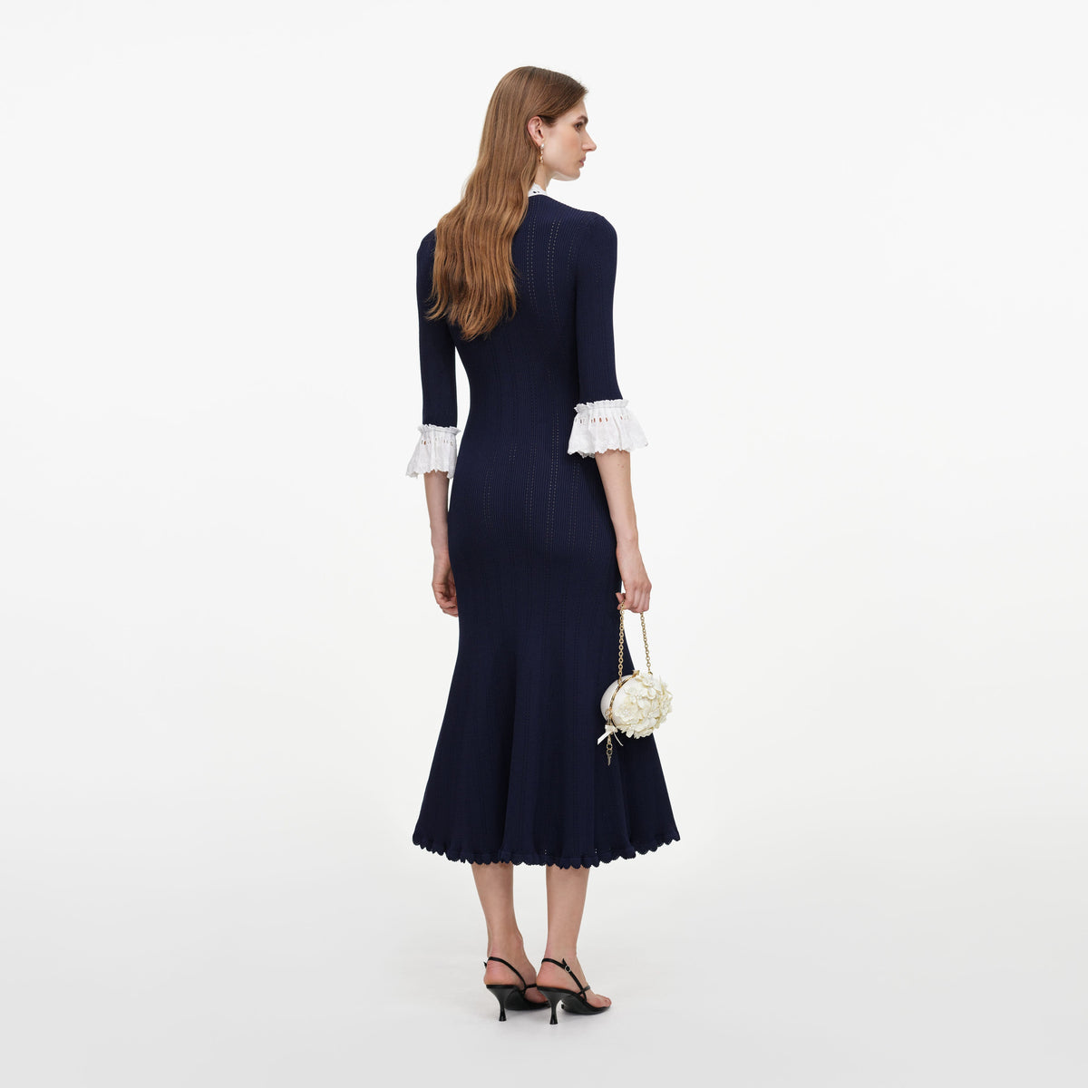 Back view of a woman wearing the Navy Pointelle Lace Knit Midi Dress