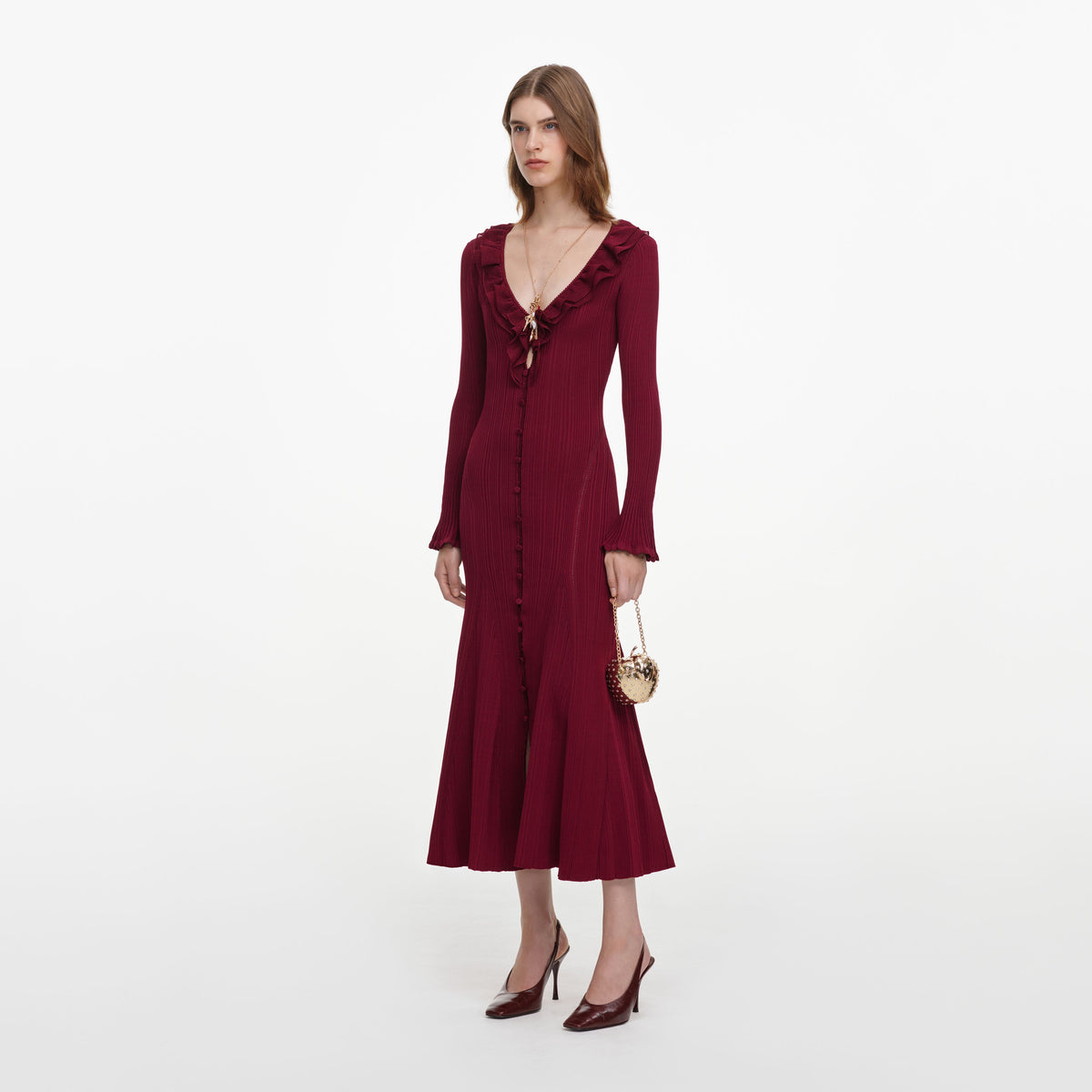 Side view of a woman wearing the Burgundy Ruffle Knit Midi Dress