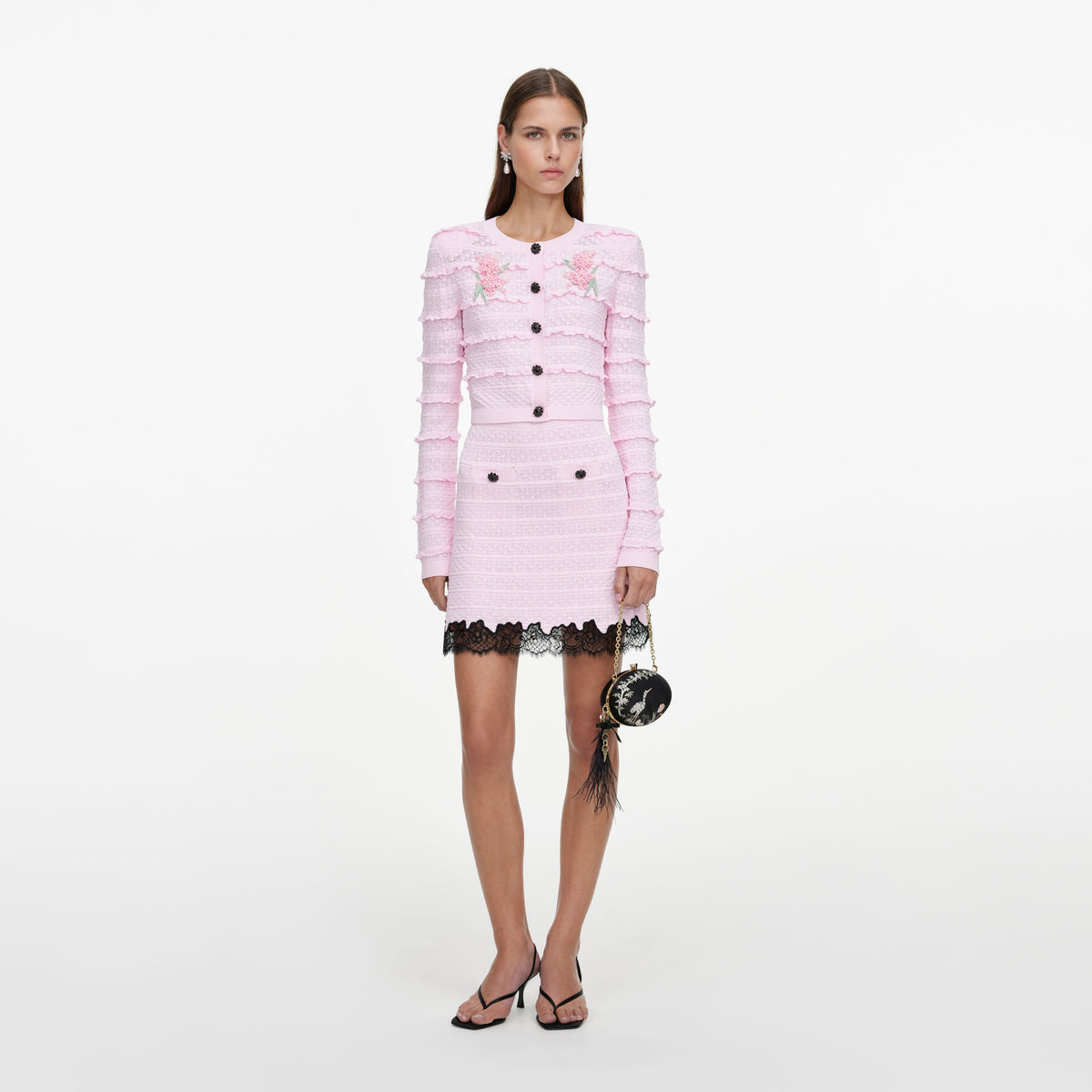 Front view of a woman wearing the Pink Pointelle Knit Skirt