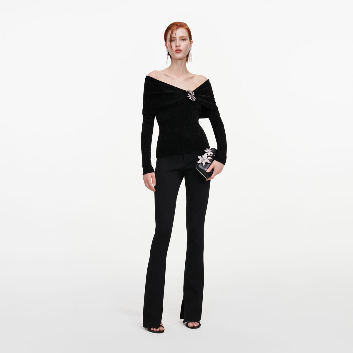 Front view of a woman wearing the Black Brooch Chenille Knit Top