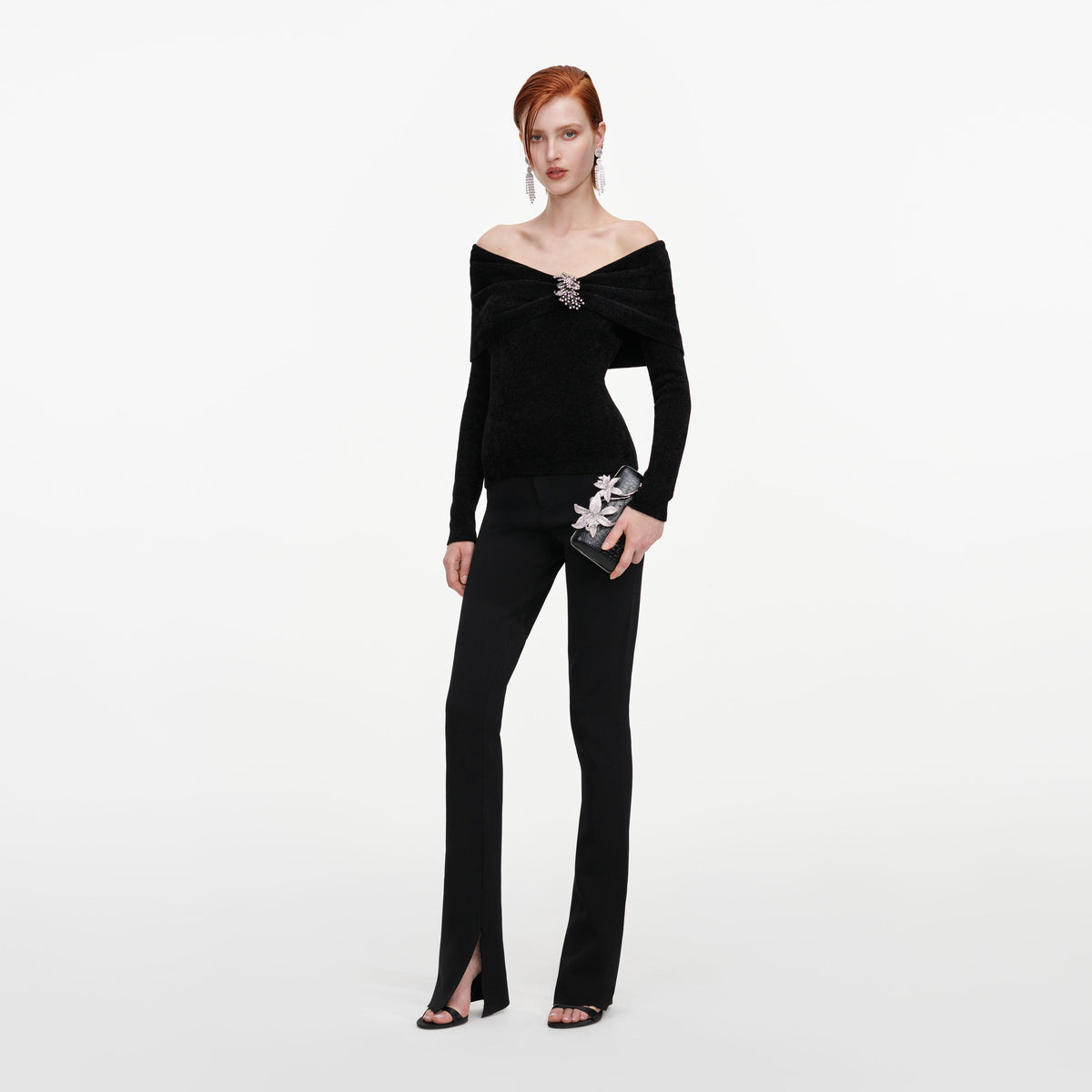Side view of a woman wearing the Black Brooch Chenille Knit Top
