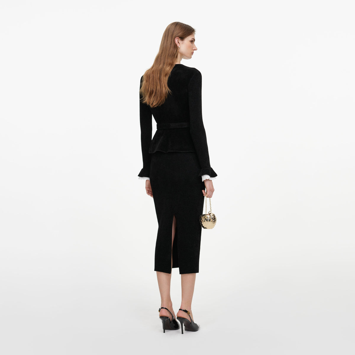 Back view of a woman wearing the Black Chenille Peplum Knit Midi Dress