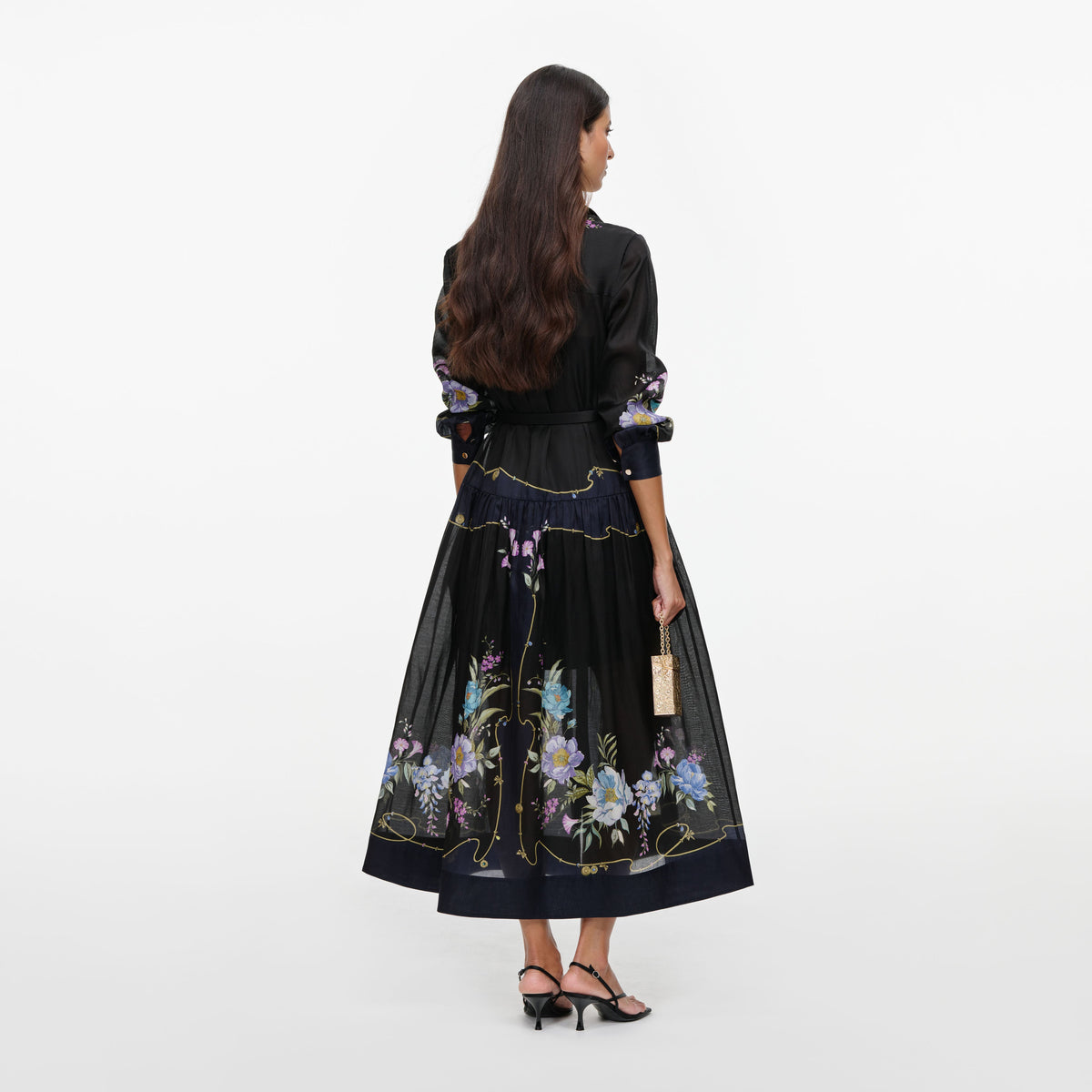 Back view of a woman wearing the Navy Floral Organza Midi Dress