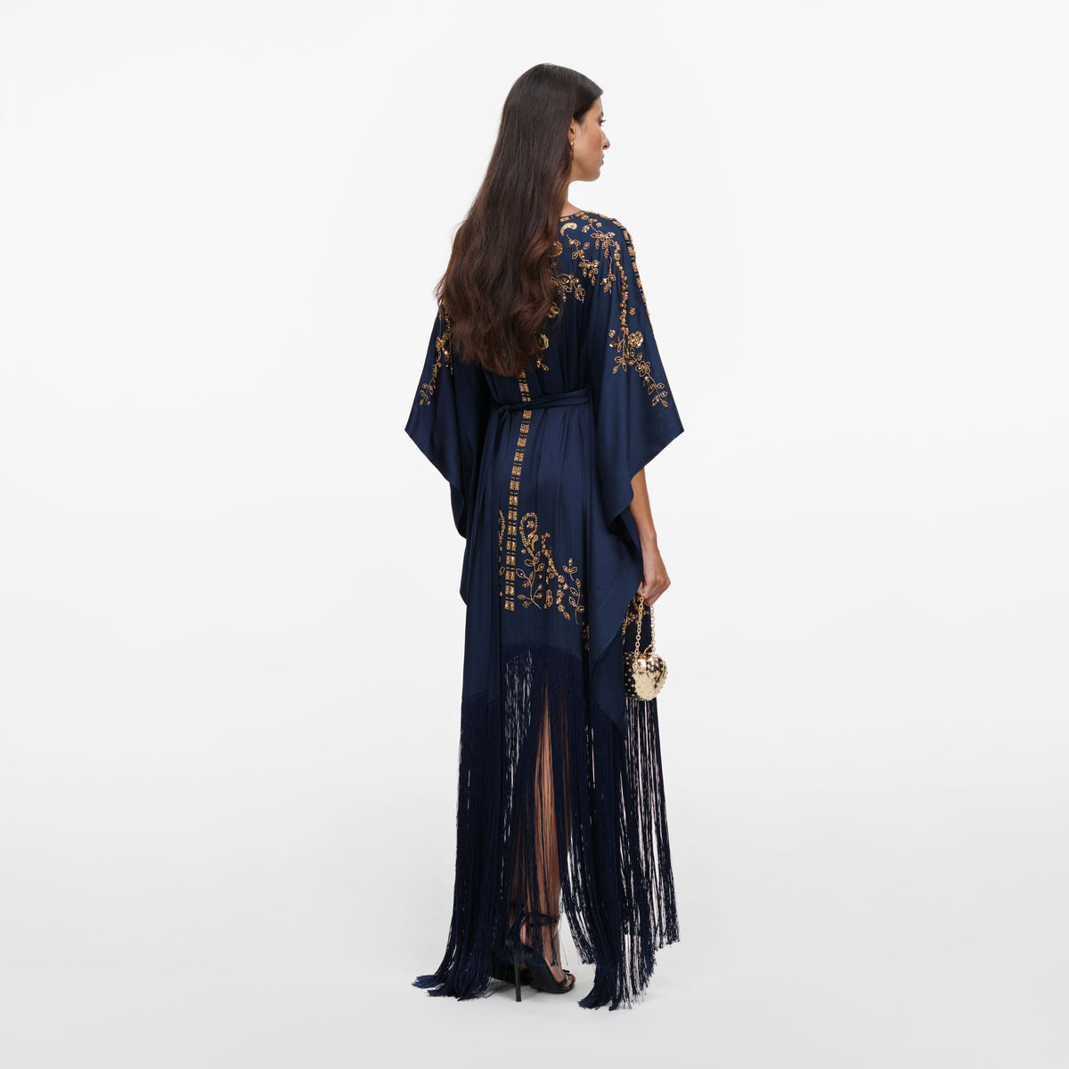 Back view of a woman wearing the Navy Sequin Embroidered Kaftan