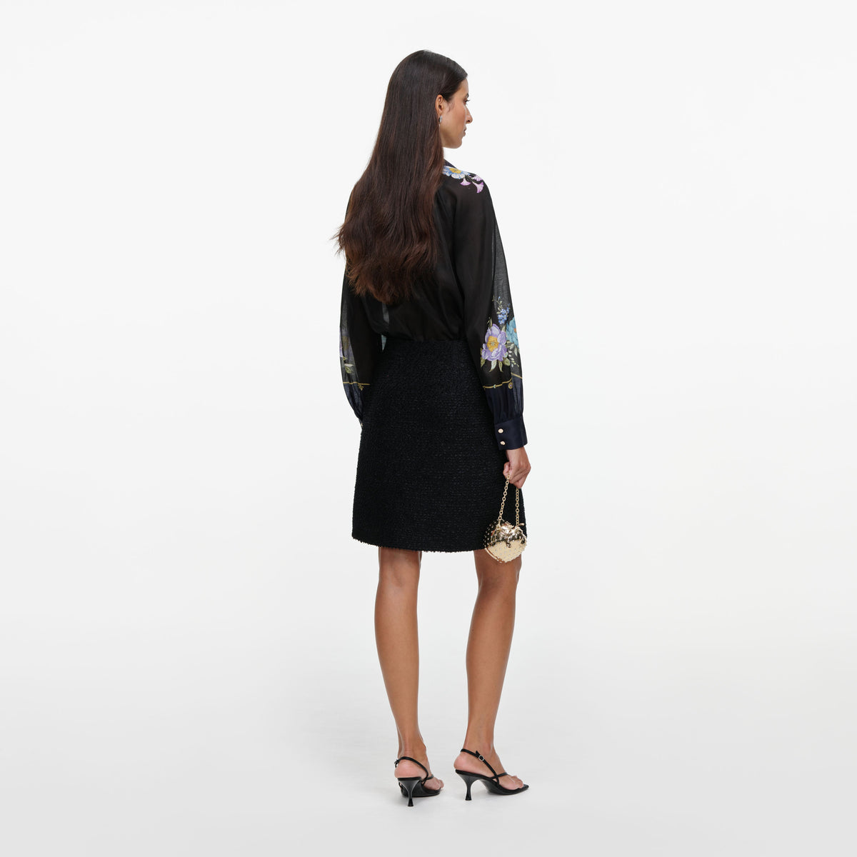 Back view of a woman wearing the Navy Floral Organza Blouse