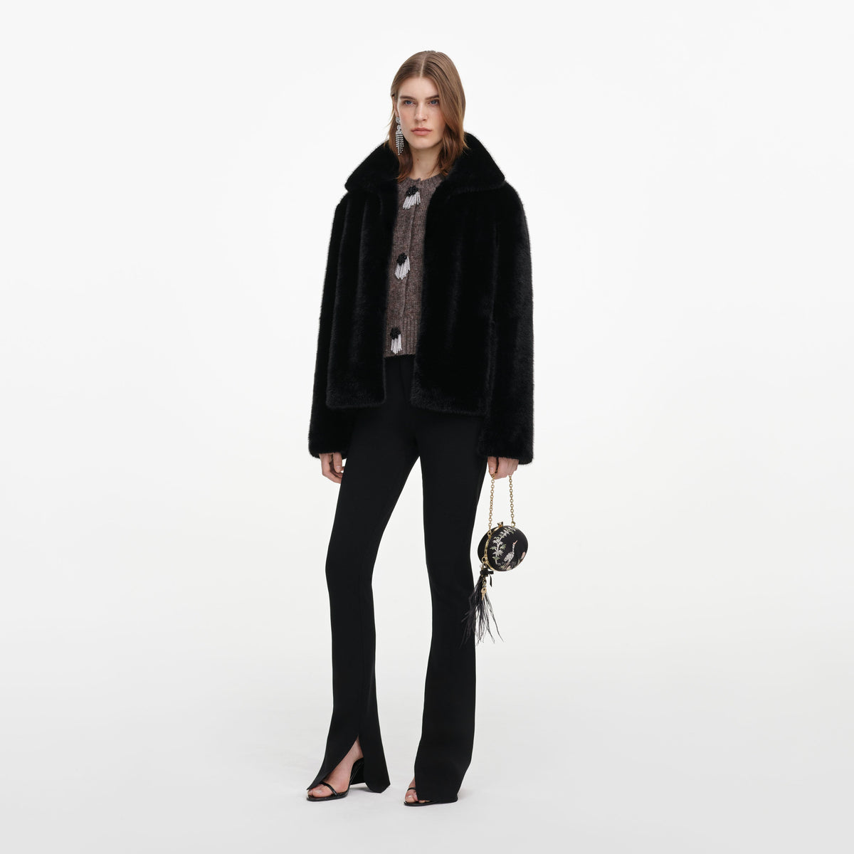 Side view of a woman wearing the Black Faux Fur Jacket