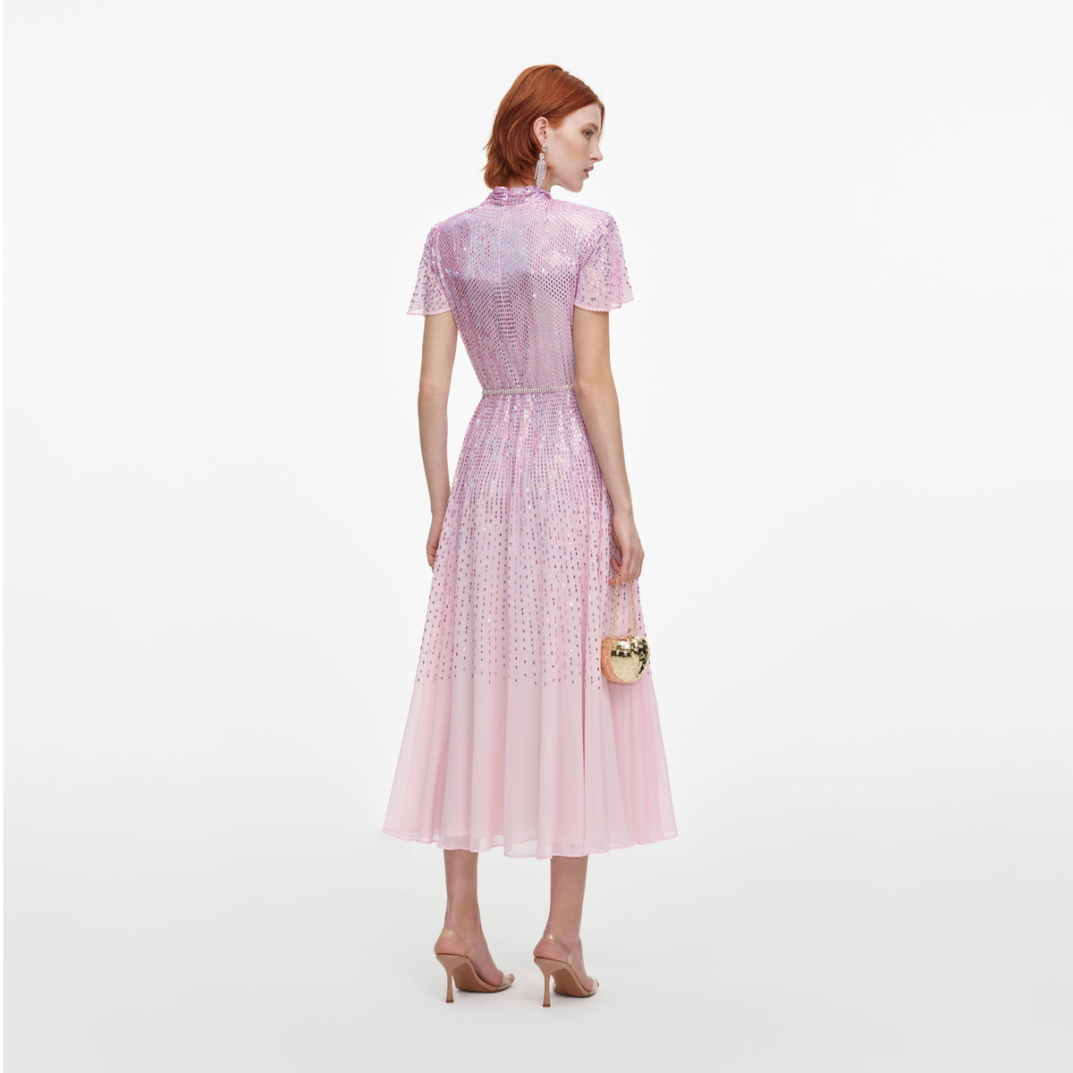 Back view of a woman wearing the Pink Ombre Rhinestone Twist Midi Dress