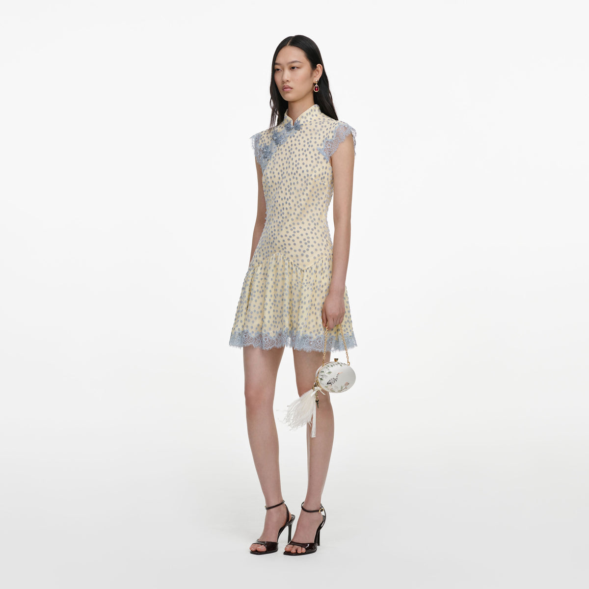 Side view of a woman wearing the Yellow Devore Polka Dot Mini Dress