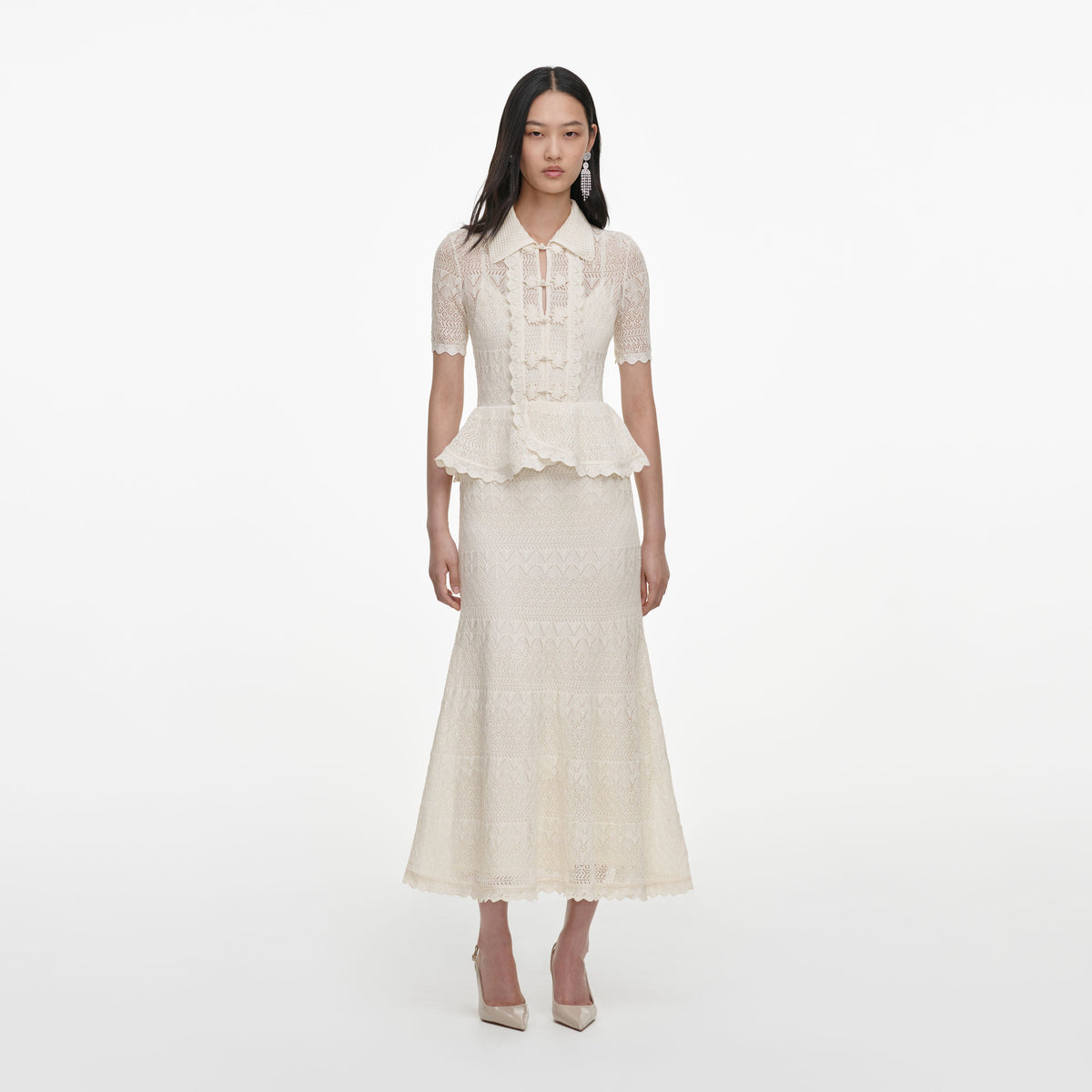 Front view of a woman wearing the Cream Pointelle Knit Wrap Peplum Midi Dress