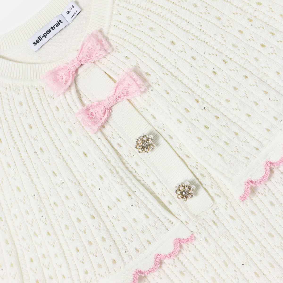 Detail Shot of the White Pointelle Knit Bow Cape Dress