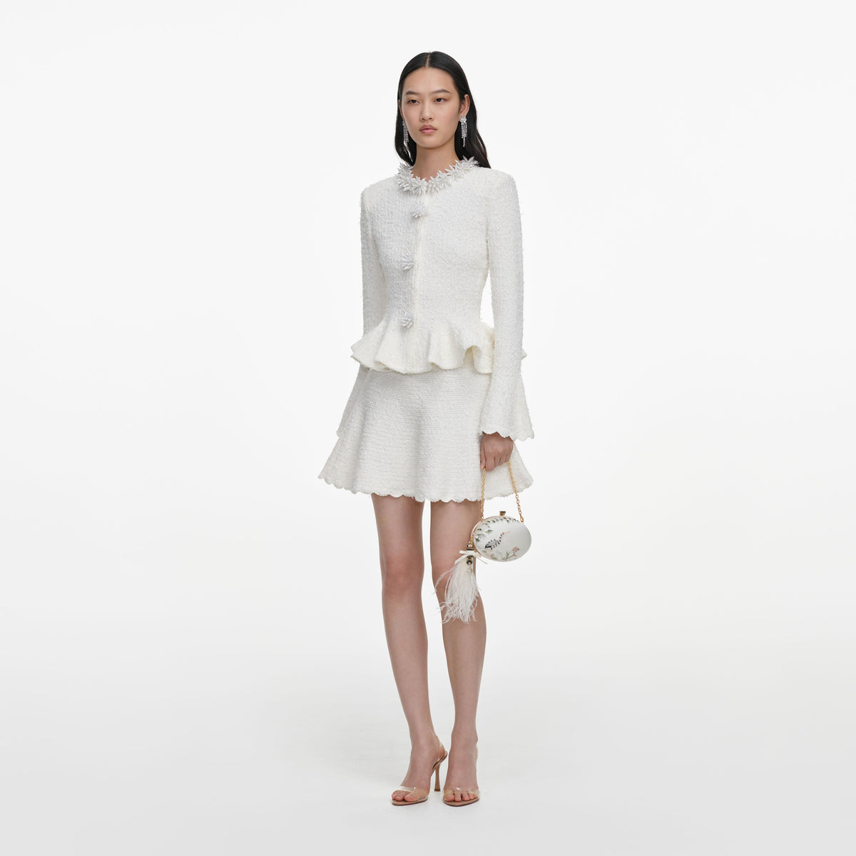 Side view of a woman wearing the White Textured Knit Mini Dress